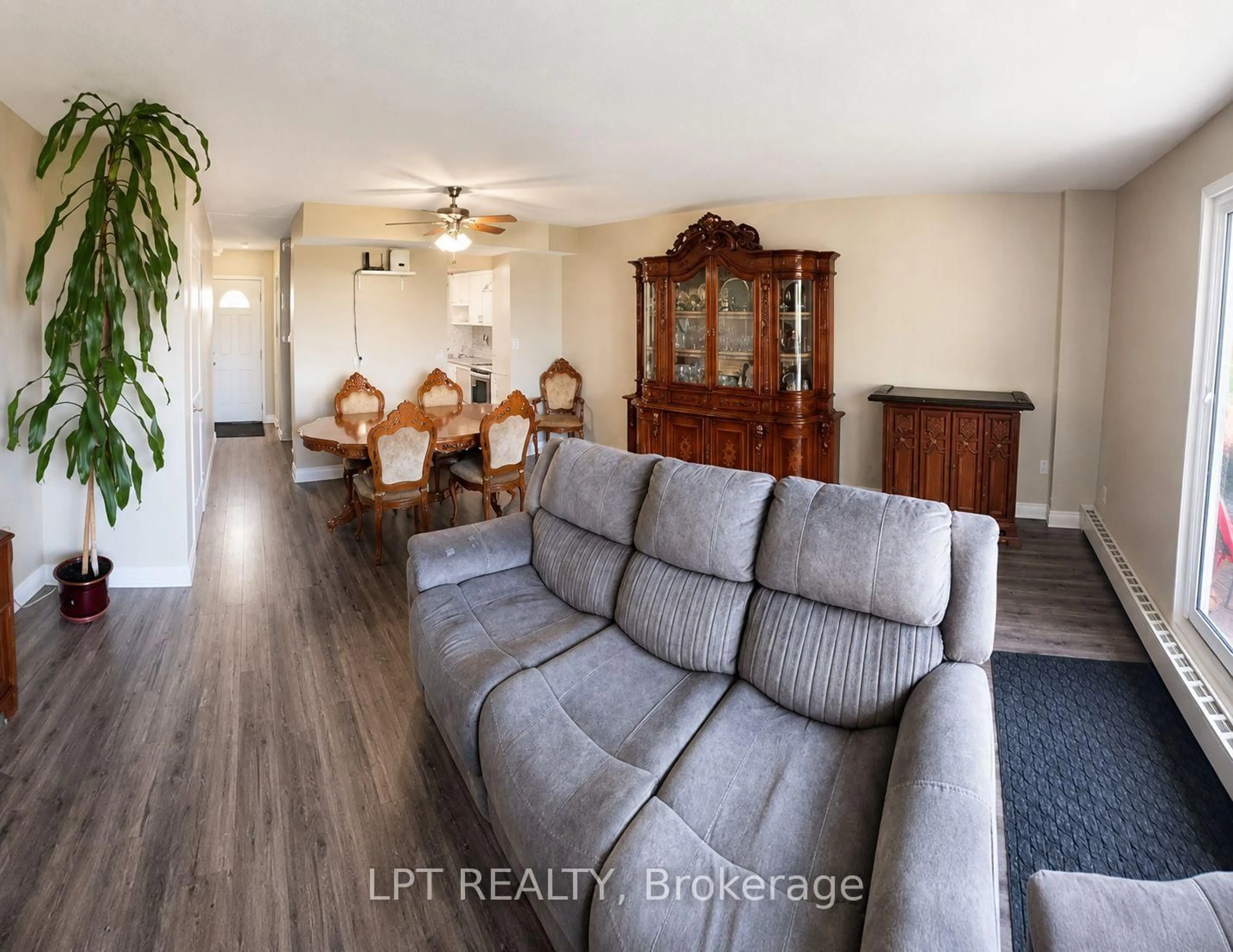 Living room with furniture, wood/laminate floor for 350 Quigley Rd #512, Hamilton Ontario L8K 5N2