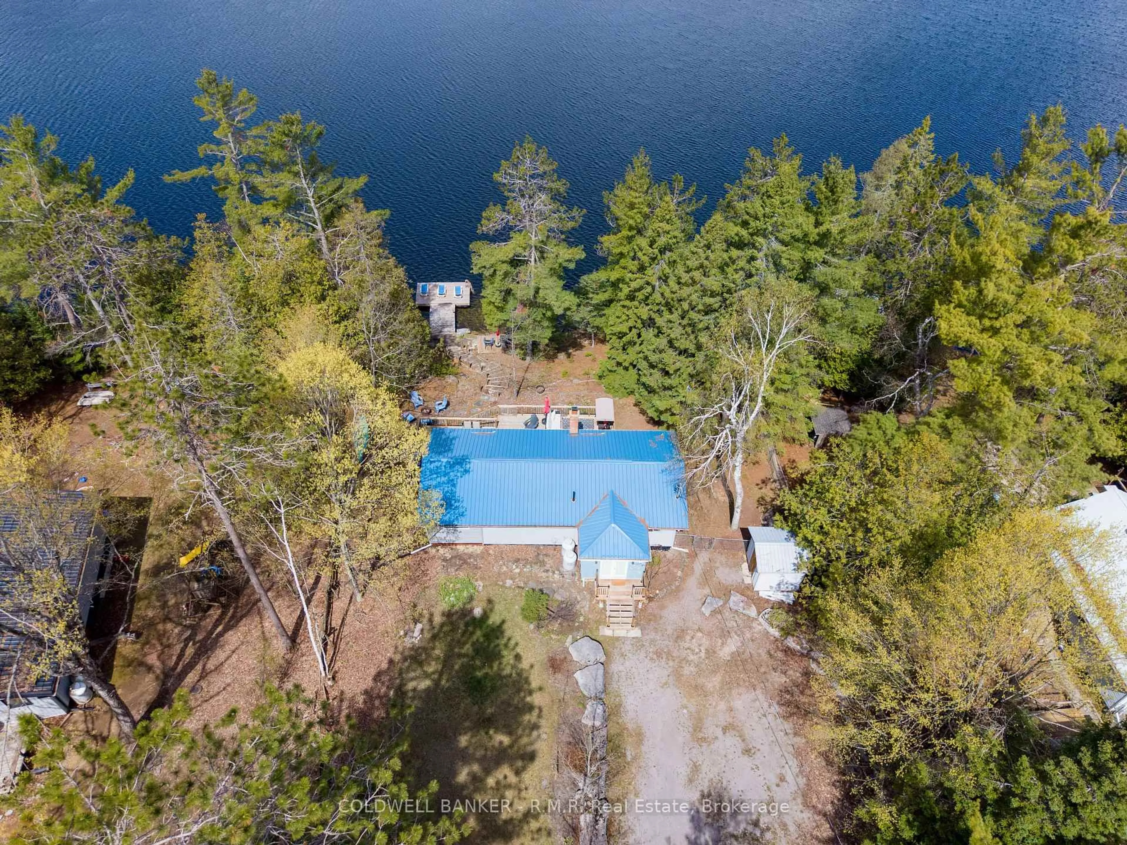 A pic from outside/outdoor area/front of a property/back of a property/a pic from drone, water/lake/river/ocean view for 63 Little Silver Lake Way, Trent Lakes Ontario K0M 1A0