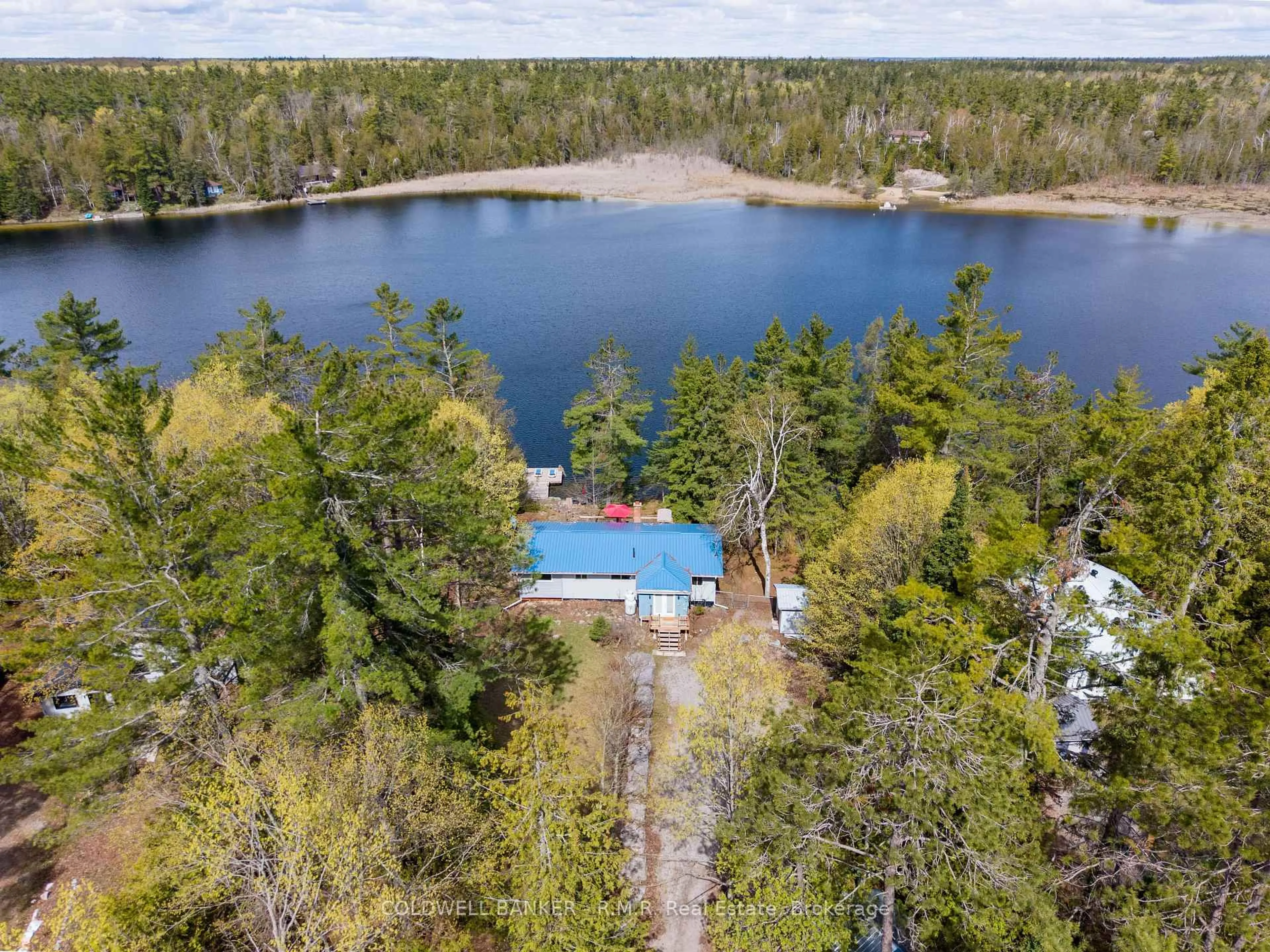 A pic from outside/outdoor area/front of a property/back of a property/a pic from drone, water/lake/river/ocean view for 63 Little Silver Lake Way, Trent Lakes Ontario K0M 1A0
