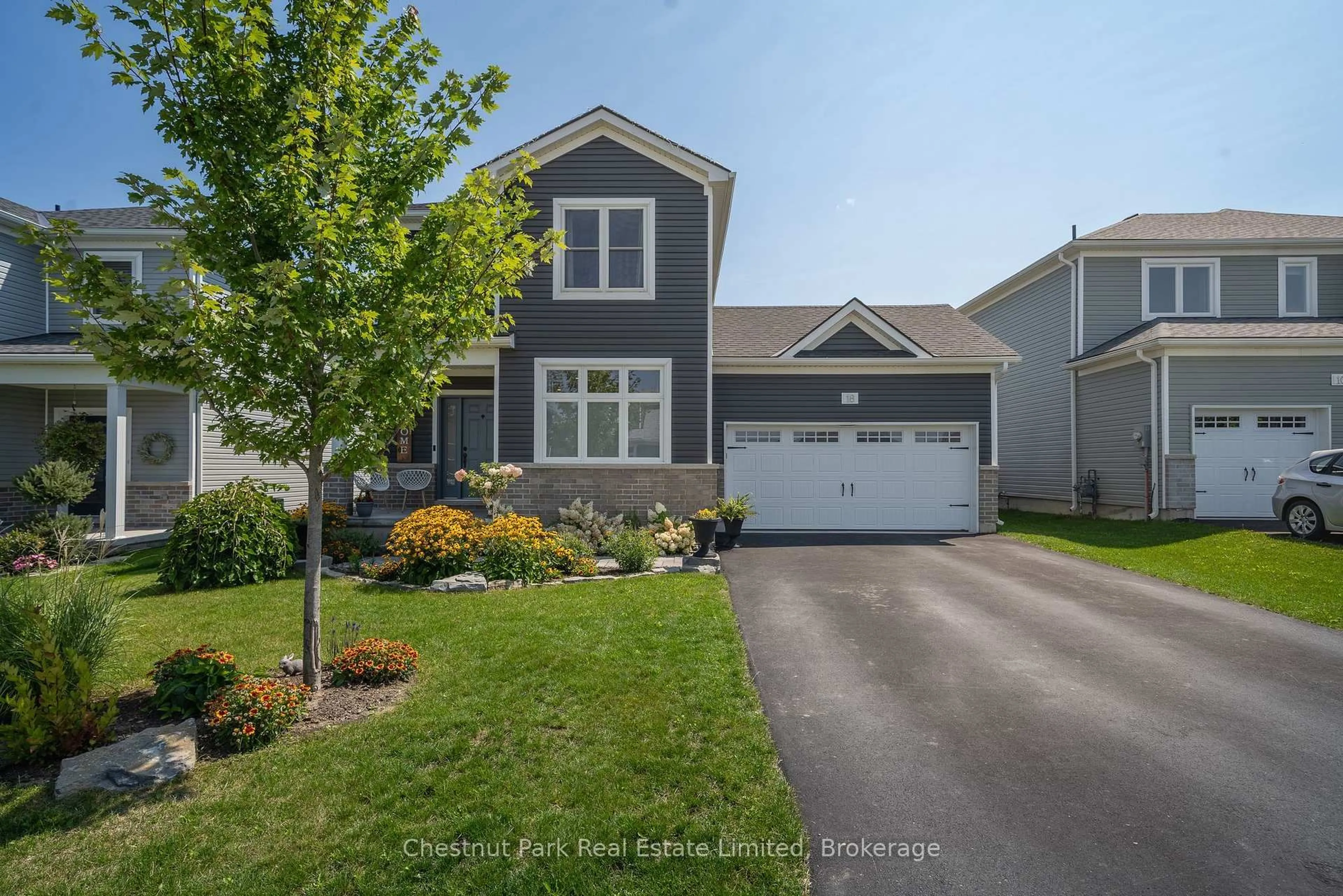 Home with vinyl exterior material, street for 18 Curtis St, Prince Edward County Ontario K0K 2T0