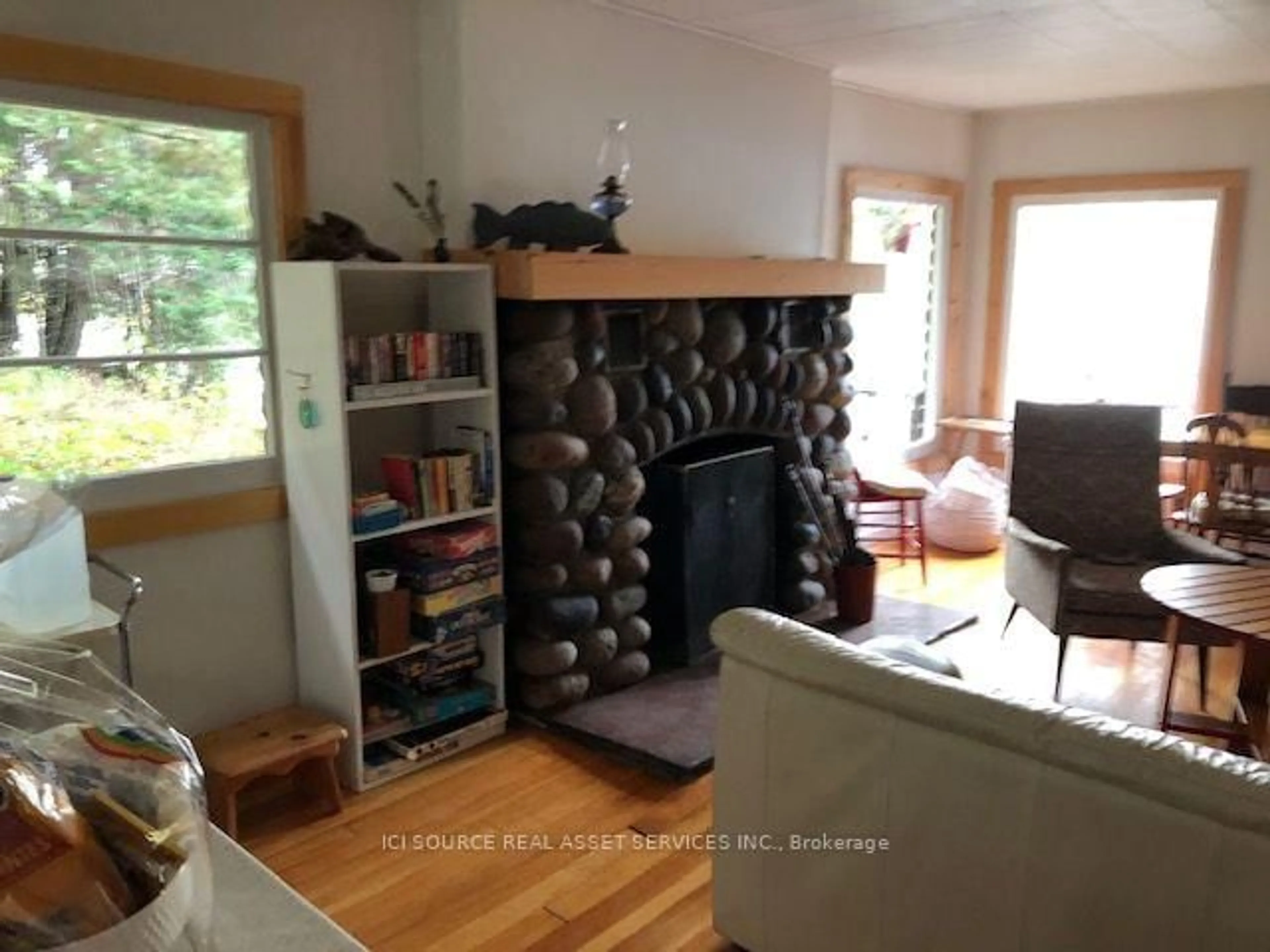Living room with furniture, wood/laminate floor for 136 Frair's Bay Rd, Huron Shores Ontario P0R 1K0