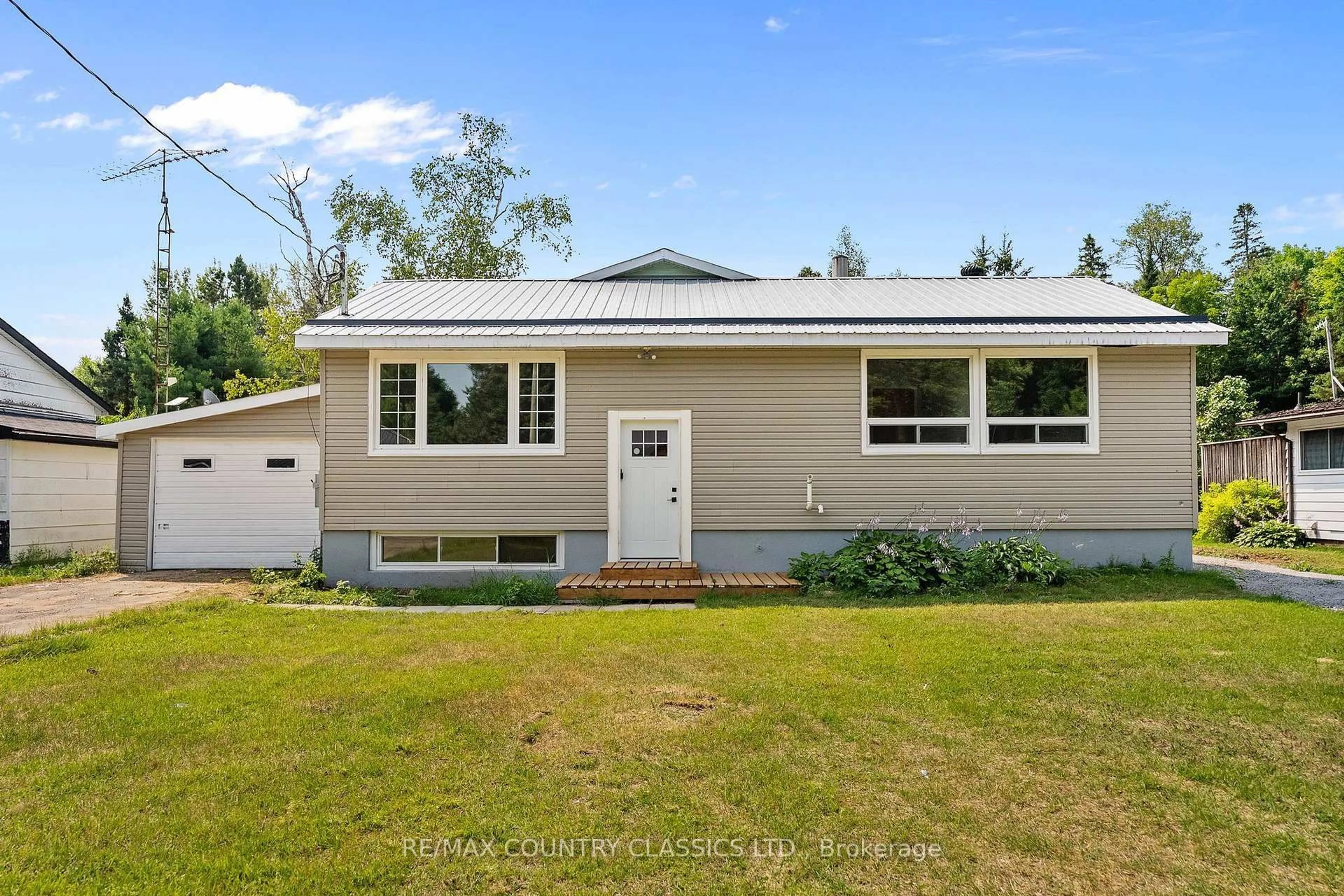 Home with vinyl exterior material, street for 1043 Estates Rd, Highlands East Ontario K0L 1C0