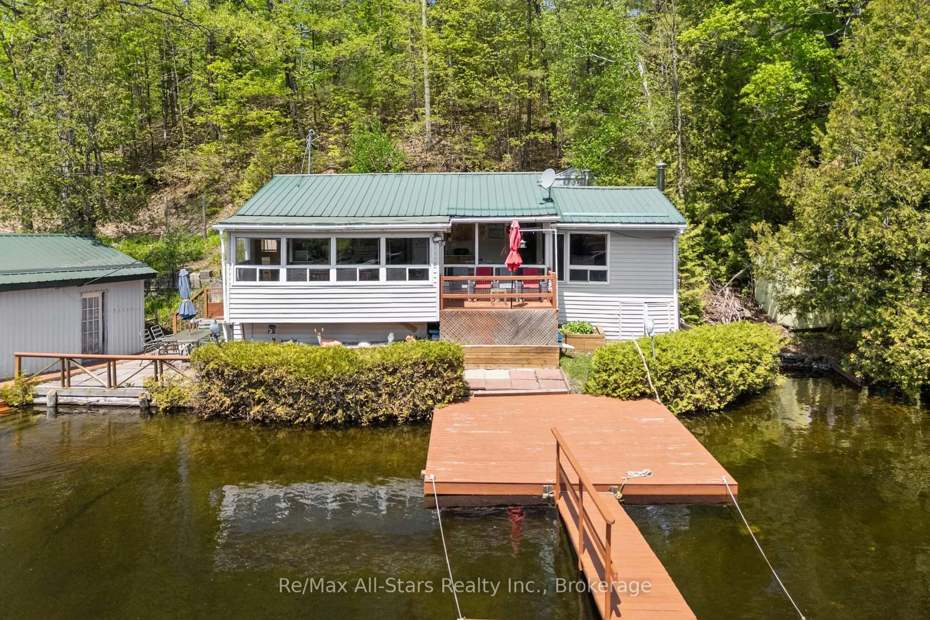 A pic from outside/outdoor area/front of a property/back of a property/a pic from drone, water/lake/river/ocean view for 55 Fire Route 393, Trent Lakes Ontario K0M 2A0