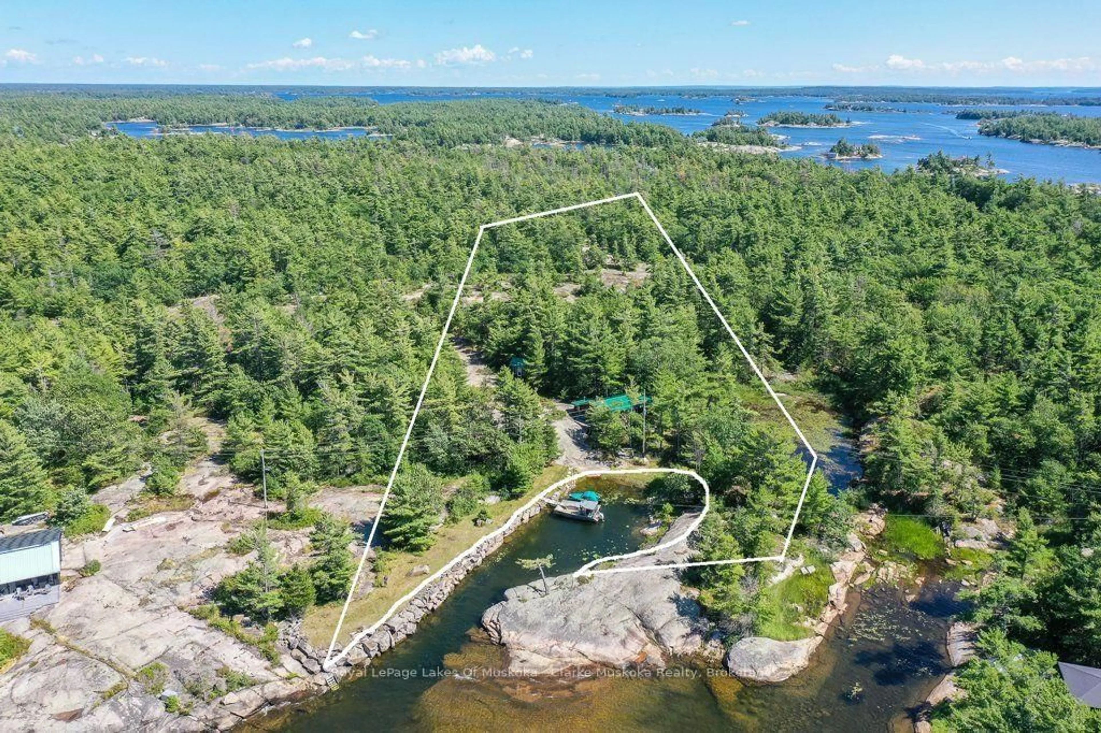A pic from outside/outdoor area/front of a property/back of a property/a pic from drone, water/lake/river/ocean view for 25744 Georgian Bay Shr, Georgian Bay Ontario P0E 1E0