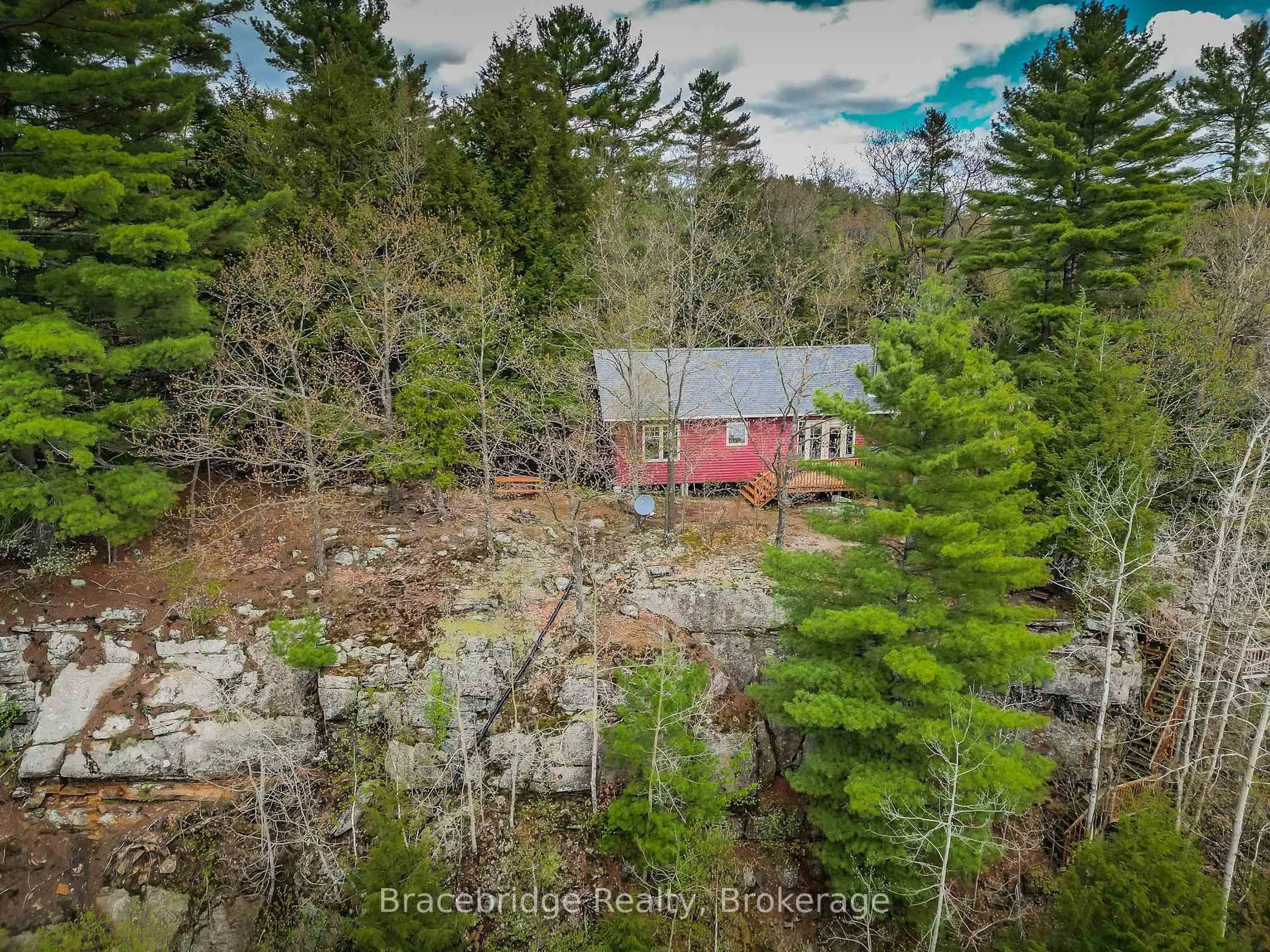 A pic from outside/outdoor area/front of a property/back of a property/a pic from drone, forest/trees view for 27 Beaumont Bay Rd, Muskoka Lakes Ontario P0B 1L0