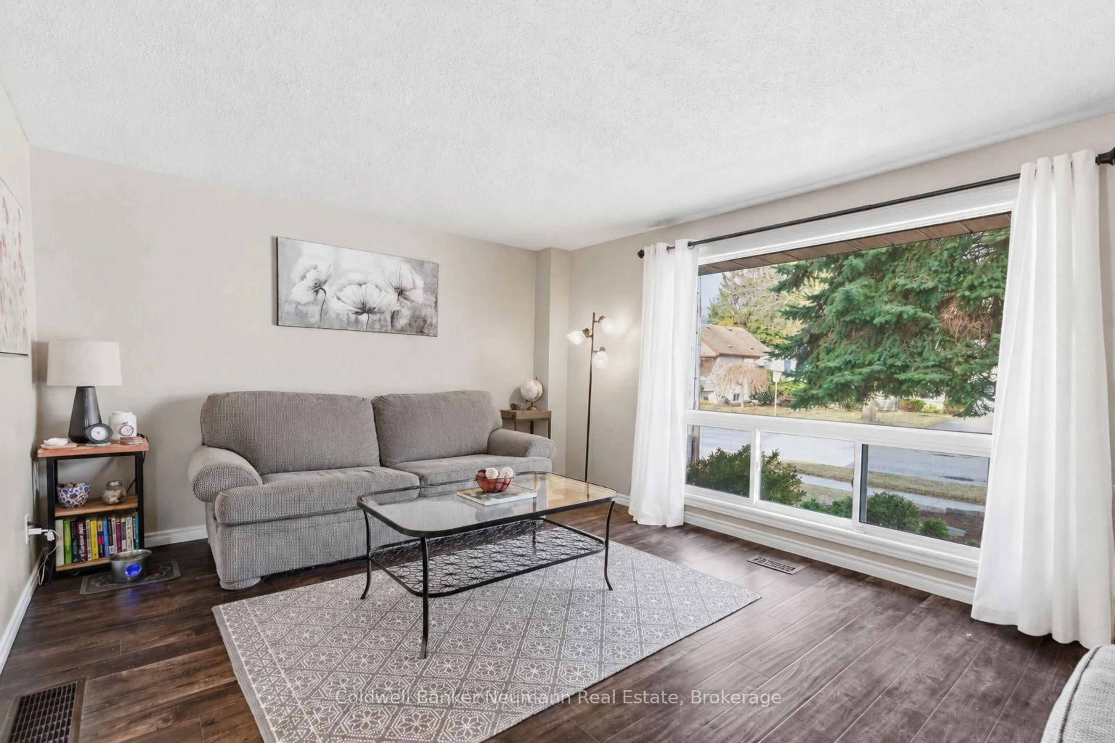 Living room with furniture, wood/laminate floor for 99 Emma St, Guelph Ontario N1E 1V1
