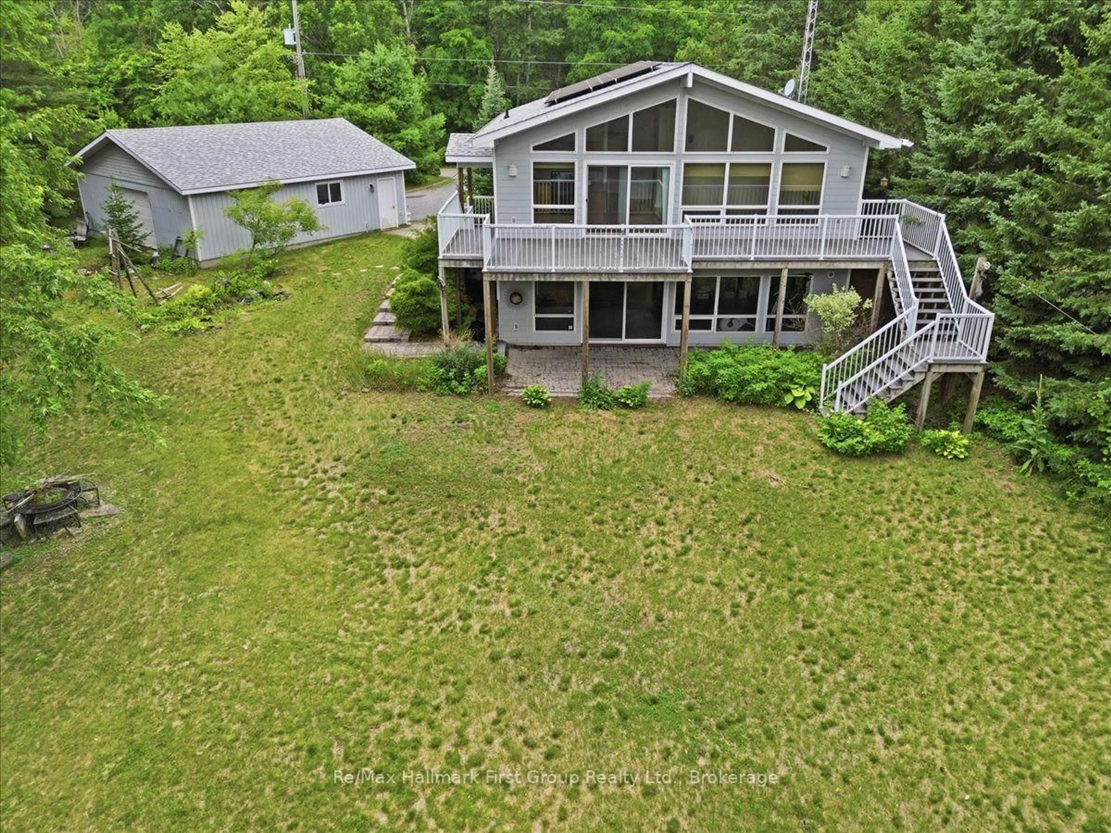 A pic from outside/outdoor area/front of a property/back of a property/a pic from drone, water/lake/river/ocean view for 32 Skootamatta Lane, Tweed Ontario K0K 3J0