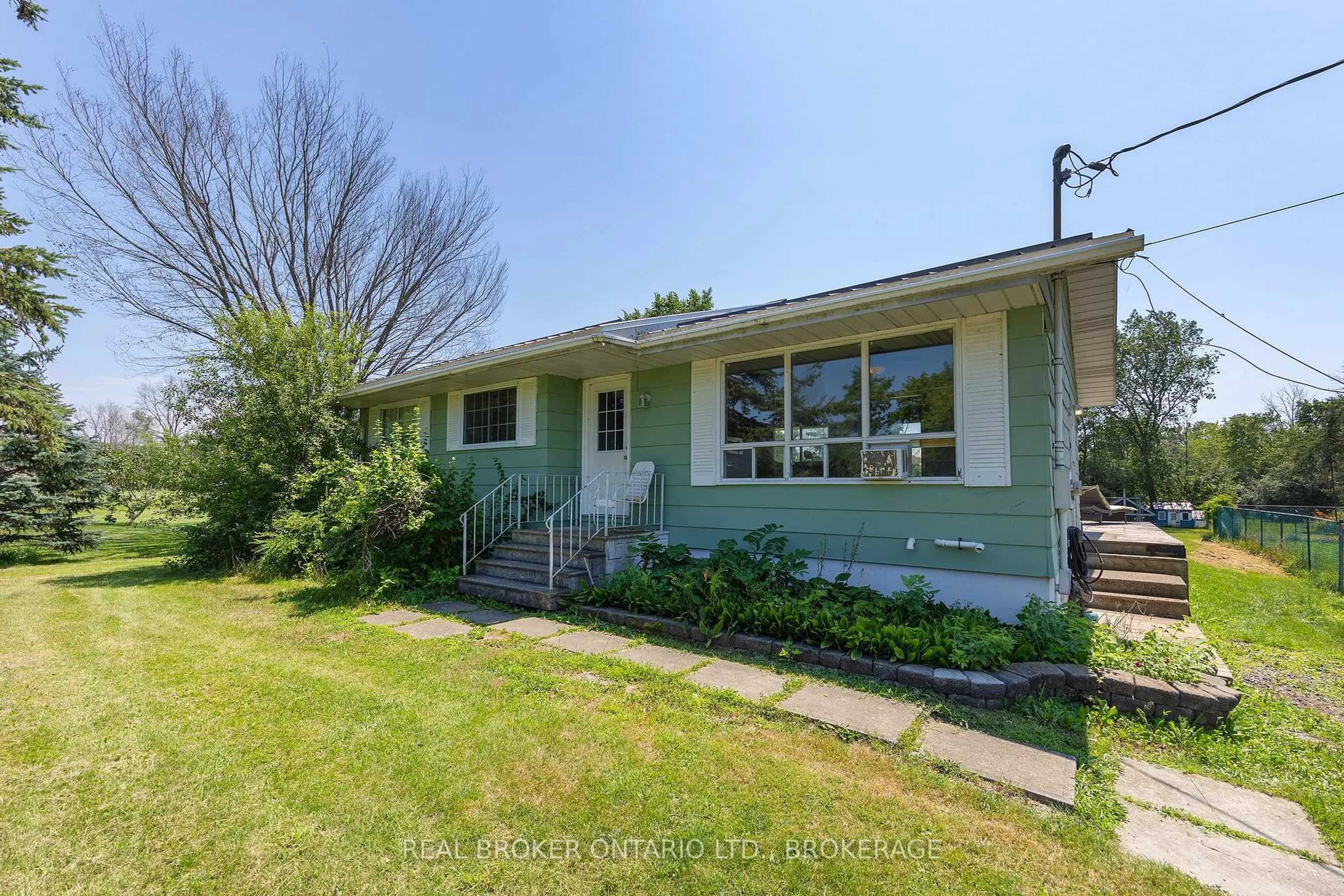 Home with vinyl exterior material, street for 1013 River Rd, Harrowsmith Ontario K0H 1V0