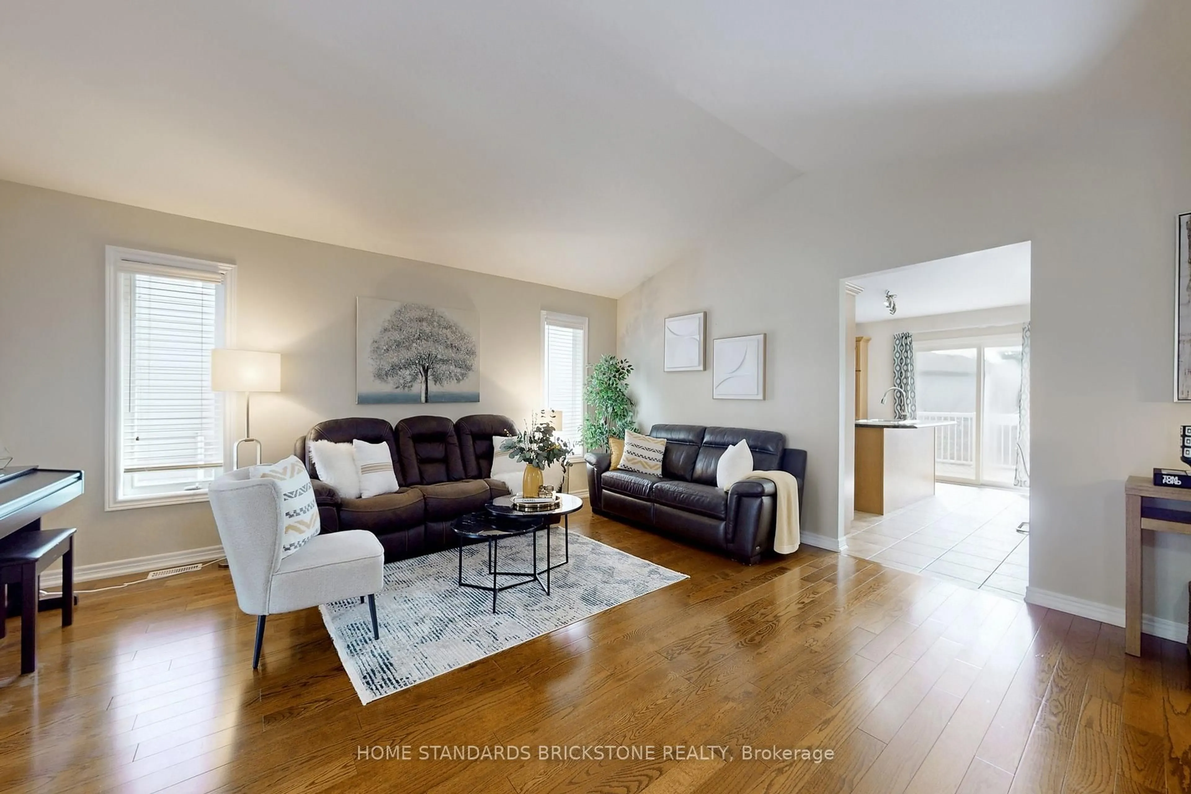 Living room with furniture, wood/laminate floor for 412 Autumn Cres, Welland Ontario L3C 7J9