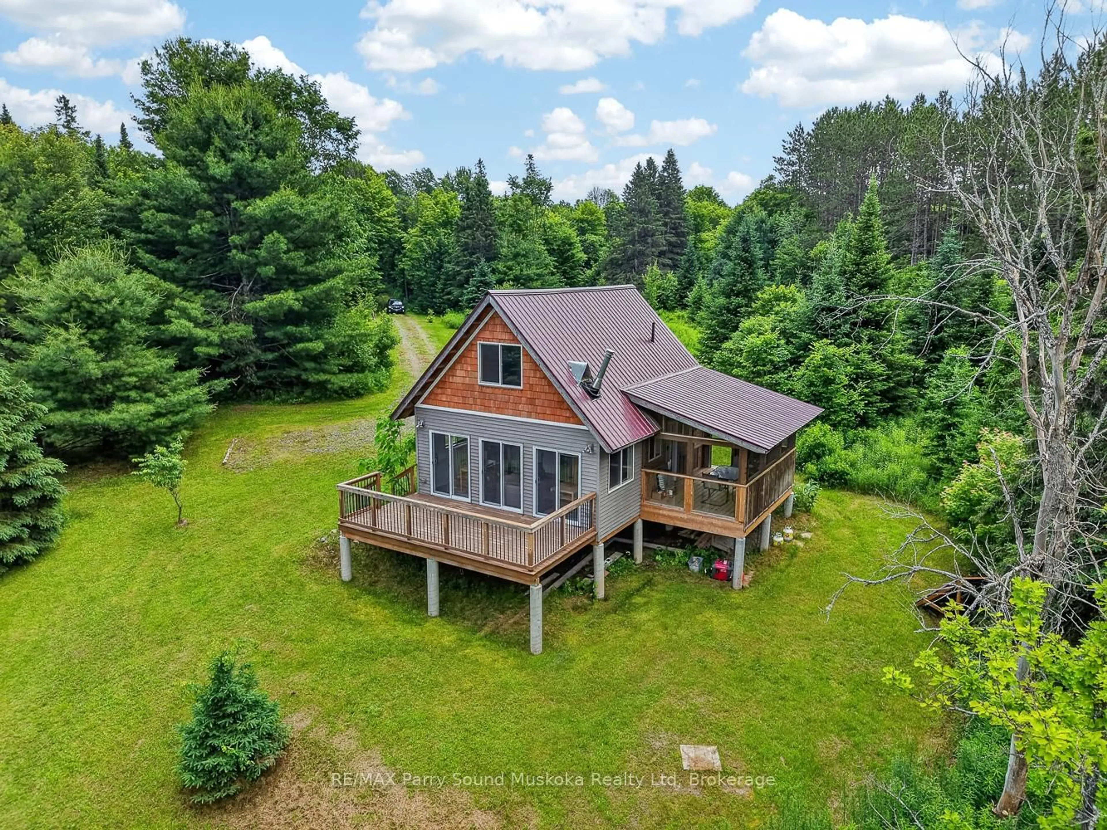 A pic from outside/outdoor area/front of a property/back of a property/a pic from drone, water/lake/river/ocean view for 39 Fire Route 200, McKellar Ontario P2A 0B4