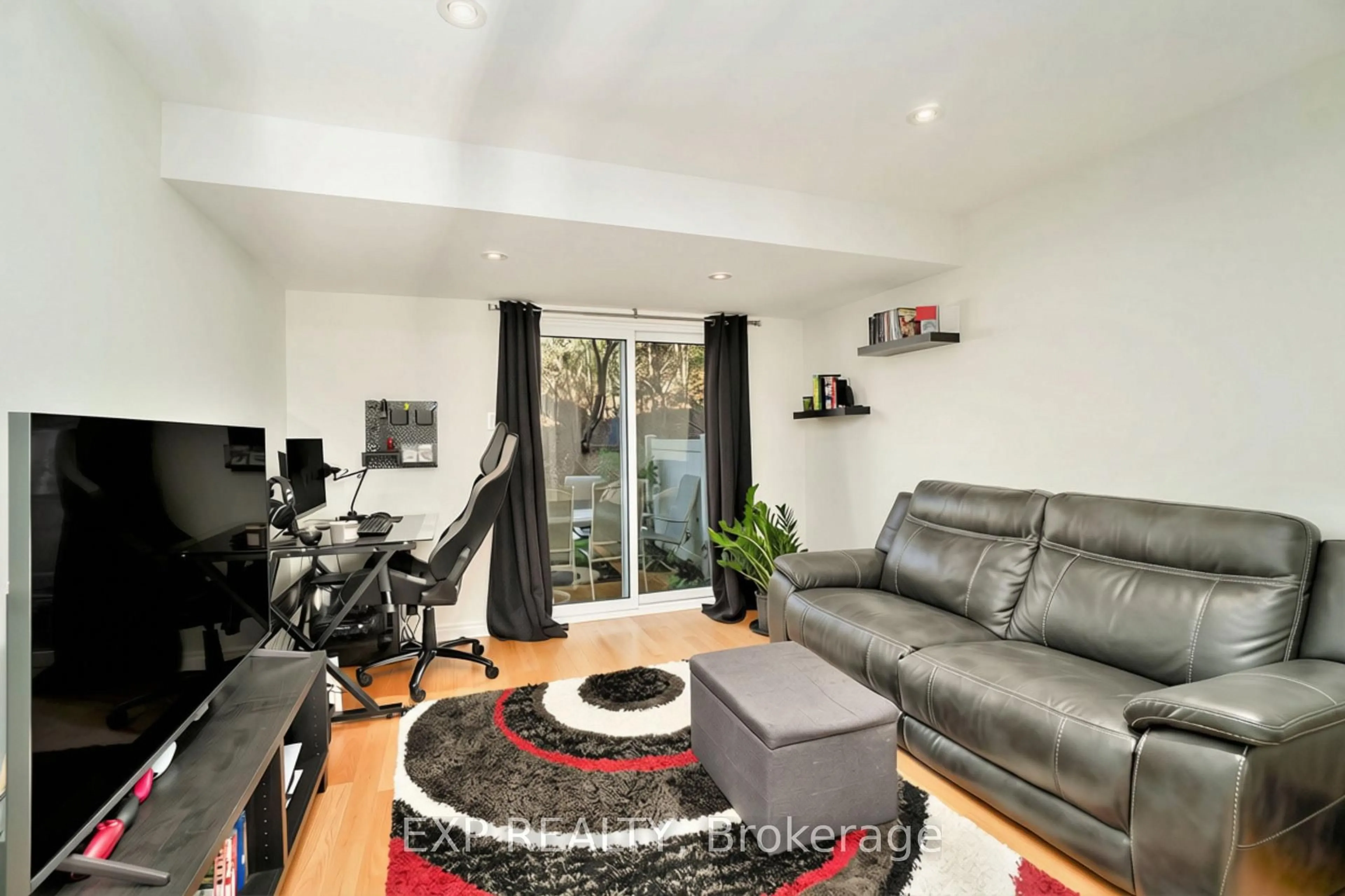 Living room with furniture, wood/laminate floor for 6667 Bilberry Dr, Ottawa Ontario K1C 4N5