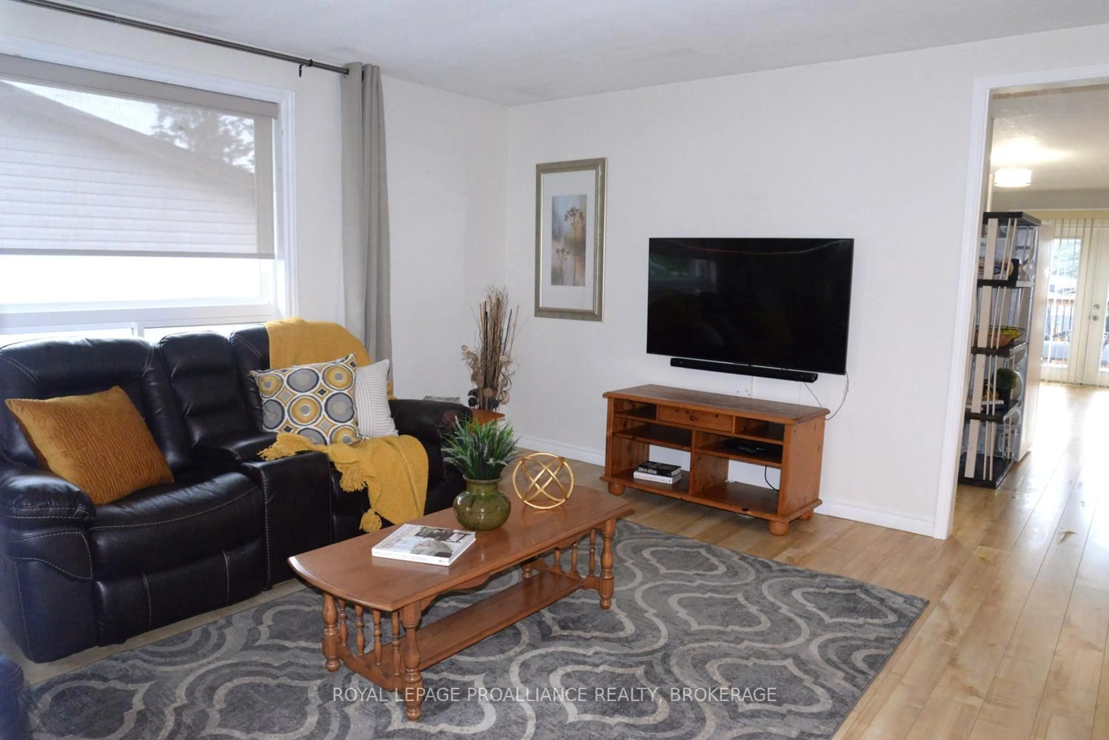 Living room with furniture, wood/laminate floor for 108 Elmwood Dr, Gananoque Ontario K7G 1N9