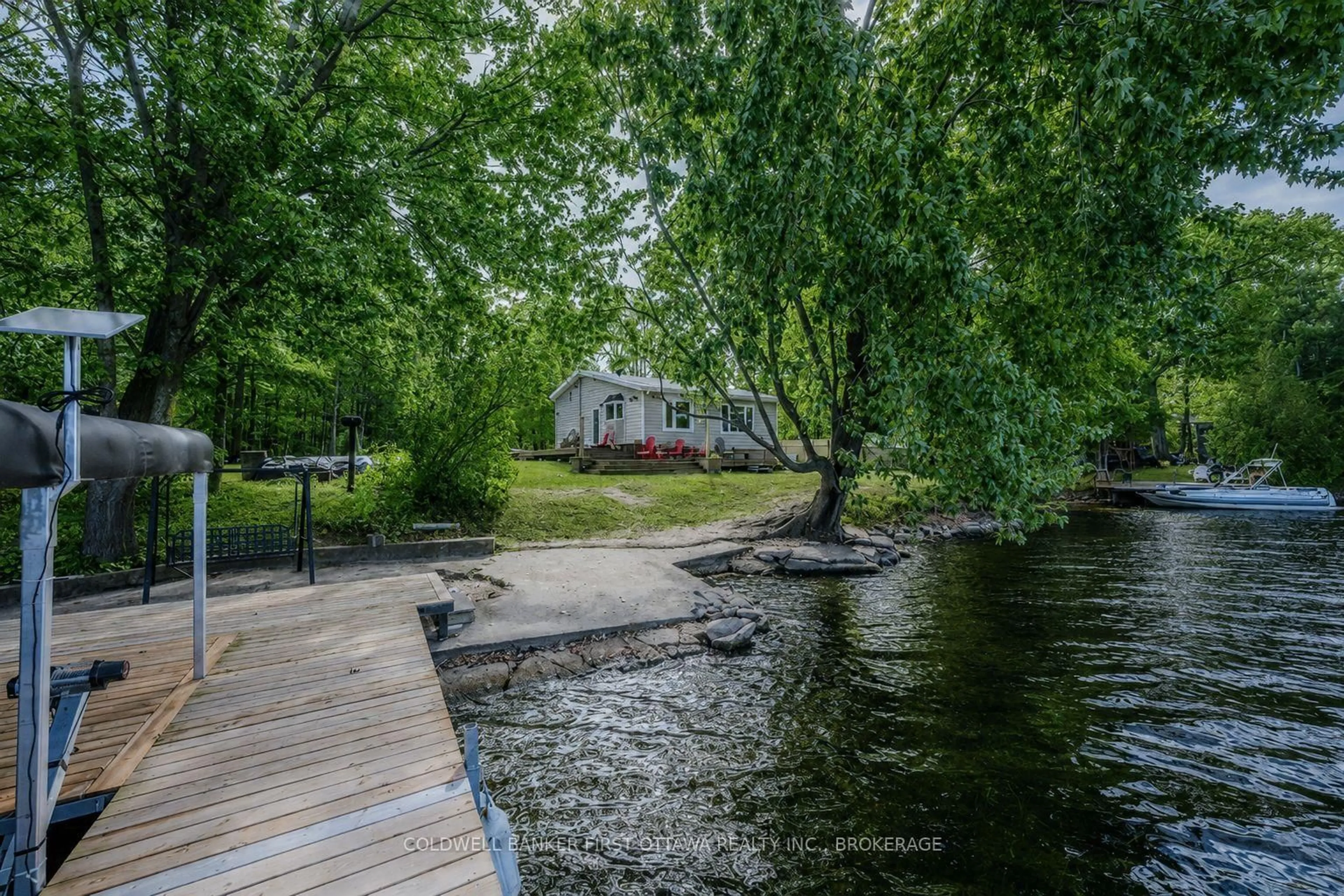 A pic from outside/outdoor area/front of a property/back of a property/a pic from drone, water/lake/river/ocean view for 1127 Perry Lane, Sydenham Ontario K0H 2T0
