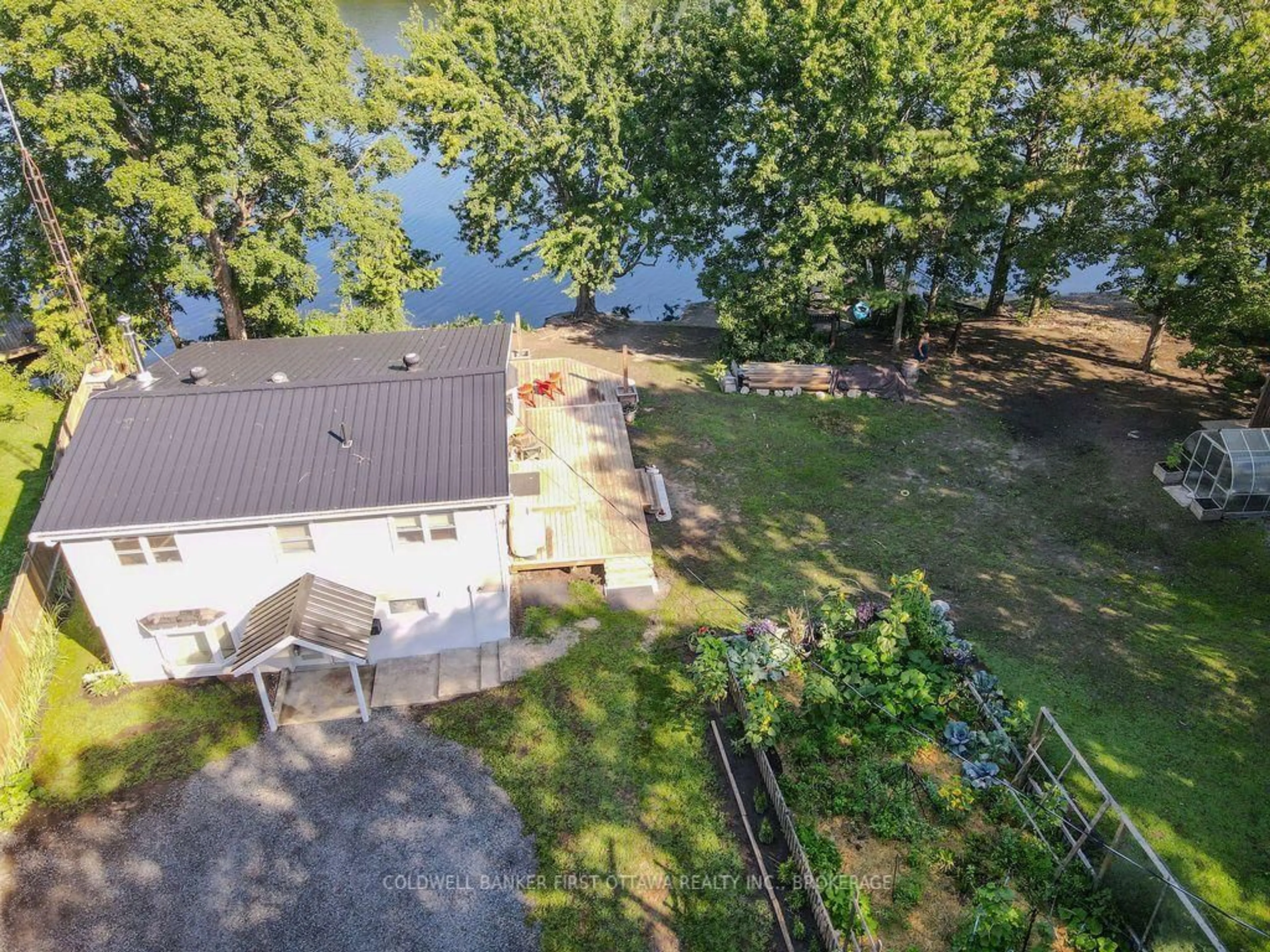 A pic from outside/outdoor area/front of a property/back of a property/a pic from drone, water/lake/river/ocean view for 1127 Perry Lane, Sydenham Ontario K0H 2T0