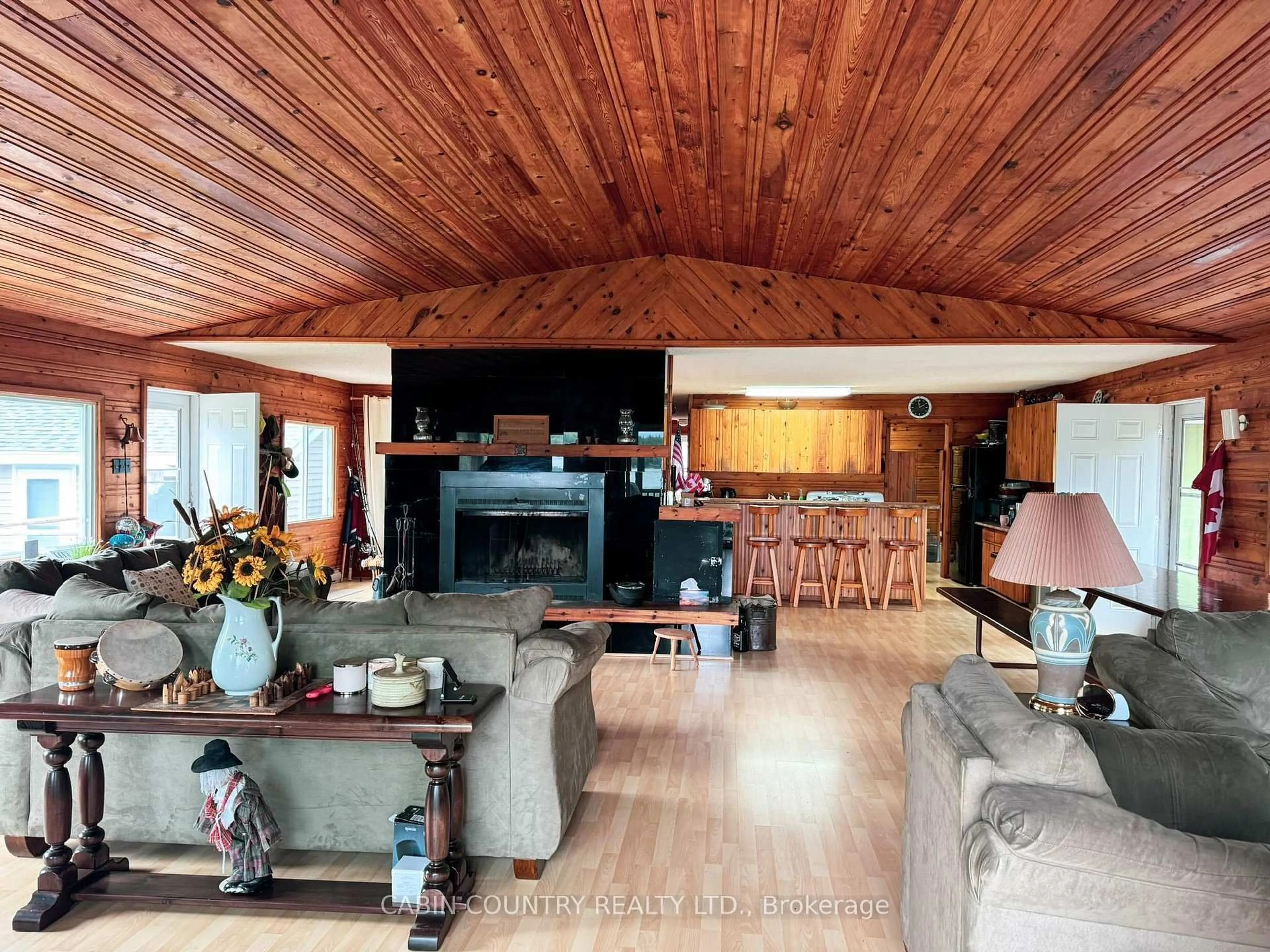 Living room with furniture, wood/laminate floor for 701A Red Pine Ridge Rd, Kenora Remote Area Ontario P0X 1C0