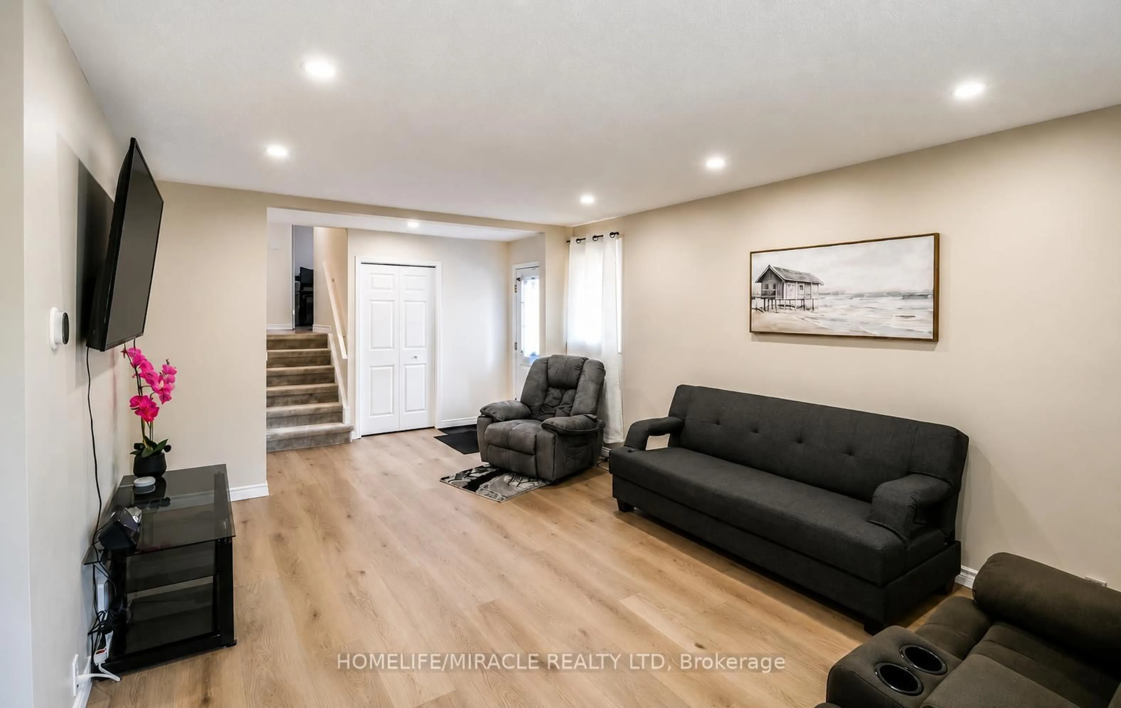 Living room with furniture, wood/laminate floor for 365 Blue Forest Dr, London North Ontario N6G 3K1