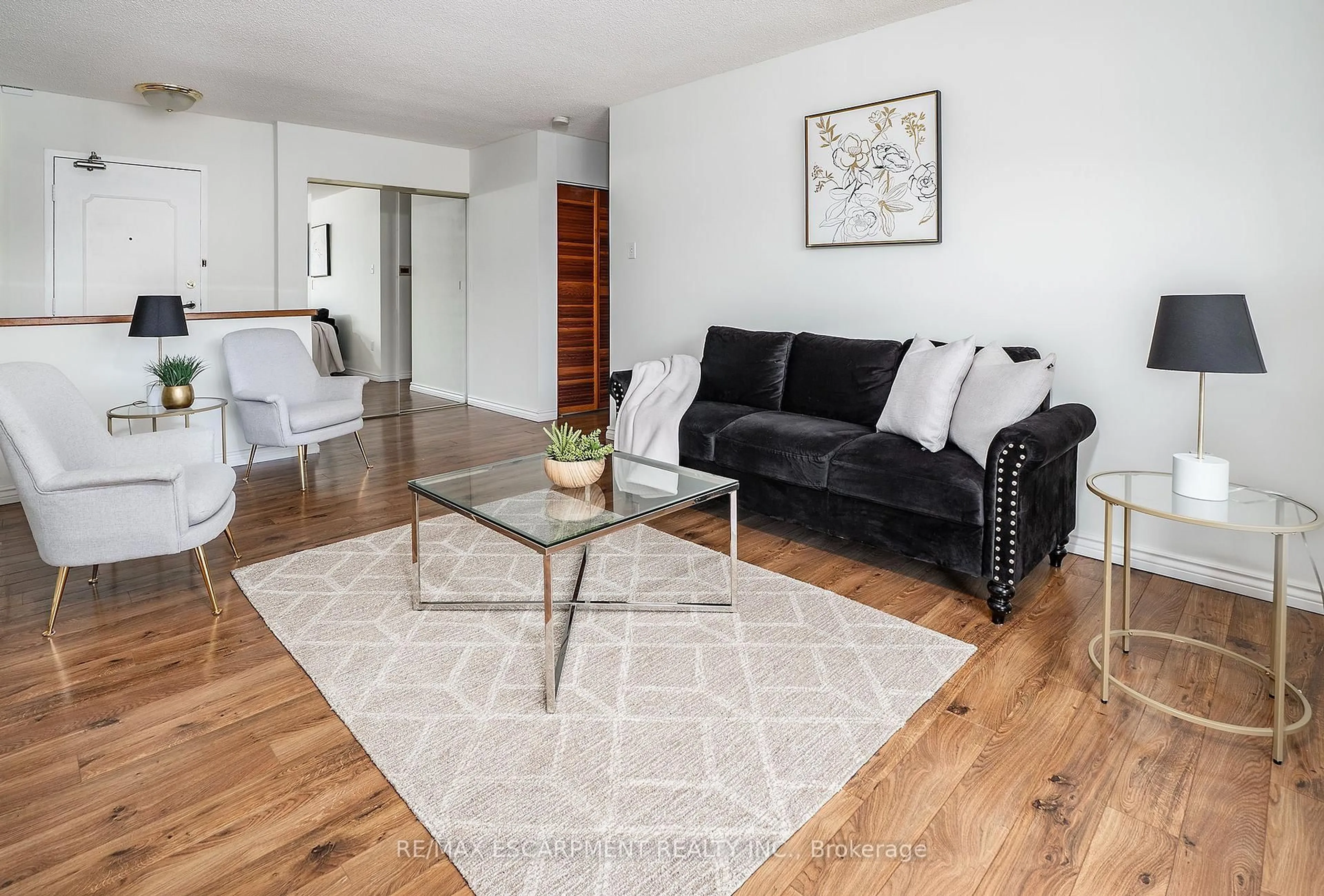 Living room with furniture, wood/laminate floor for 1964 Main St #1009, Hamilton Ontario L8S 1J5