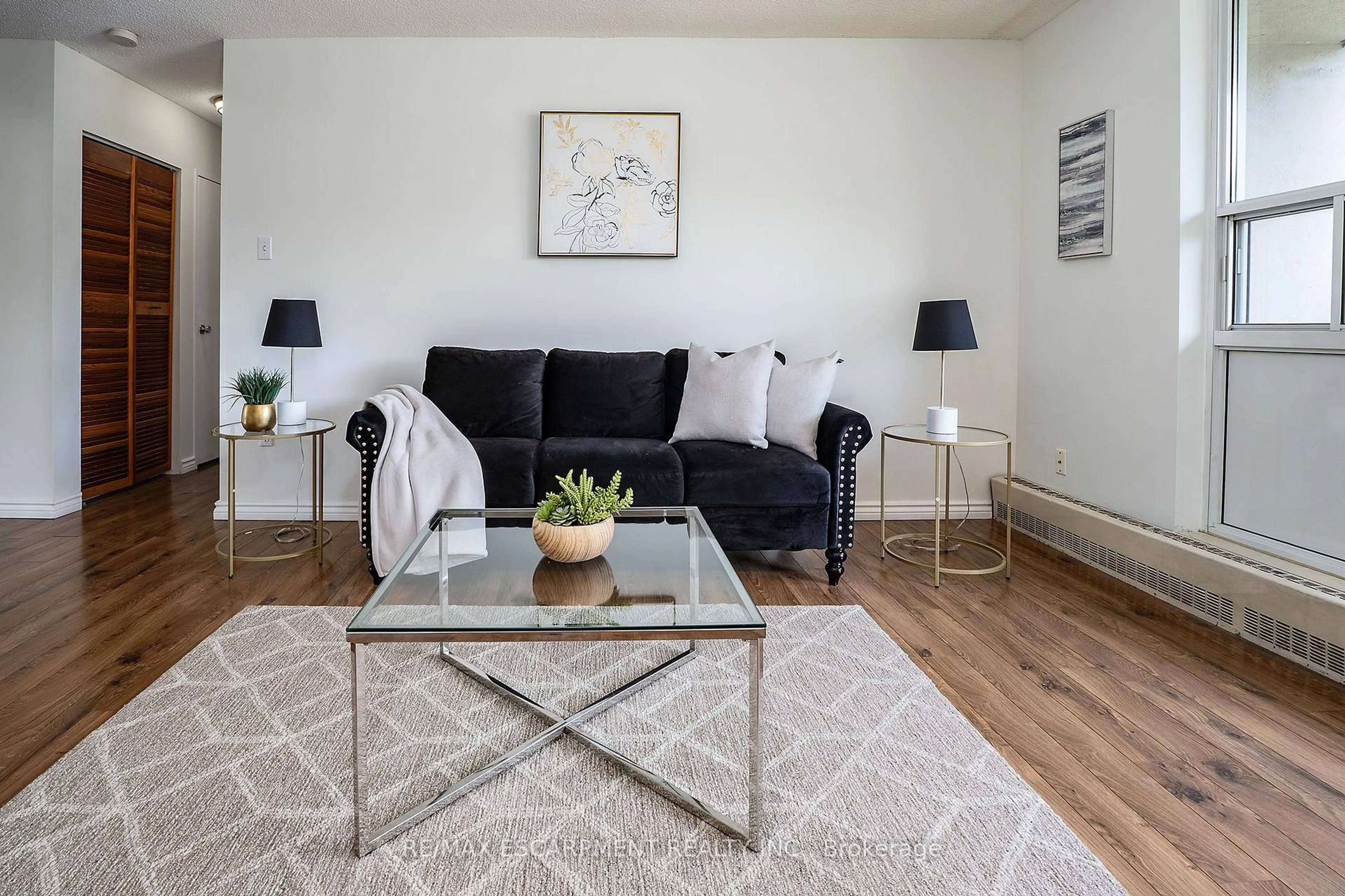 Living room with furniture, wood/laminate floor for 1964 Main St #1009, Hamilton Ontario L8S 1J5