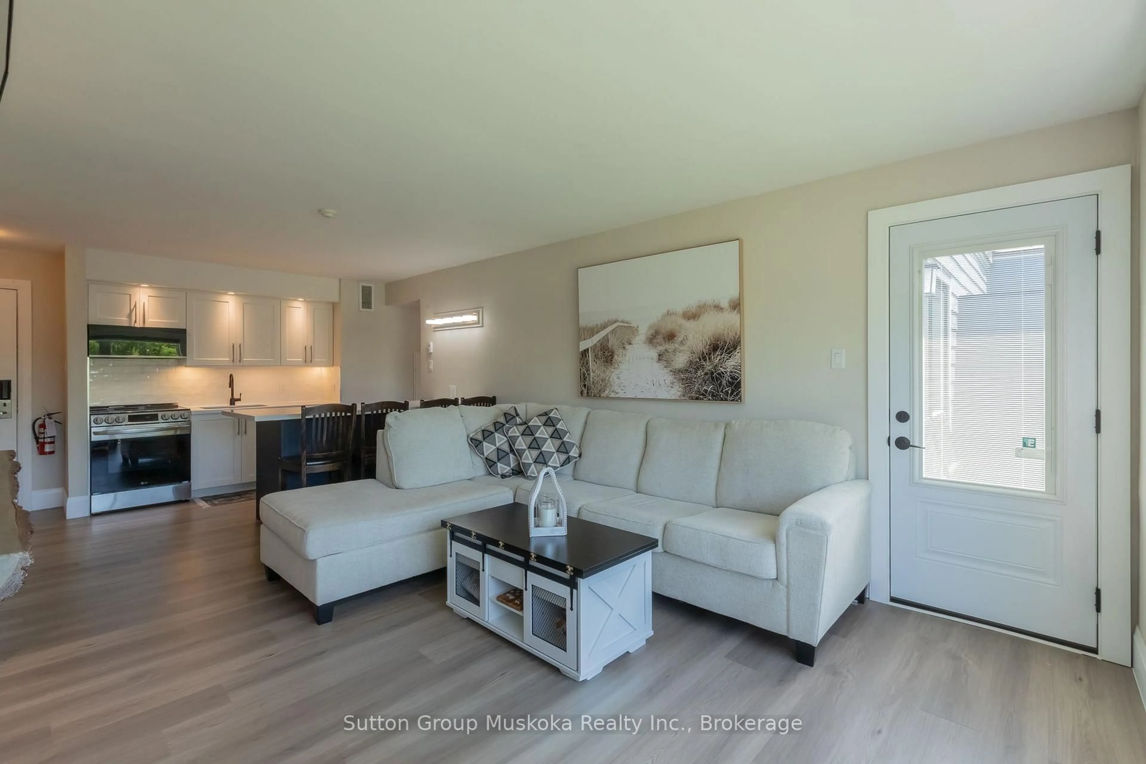 Living room with furniture, wood/laminate floor for 54-305 Deerhurst, Summit Lodge Dr #54, Huntsville Ontario P1H 2E8