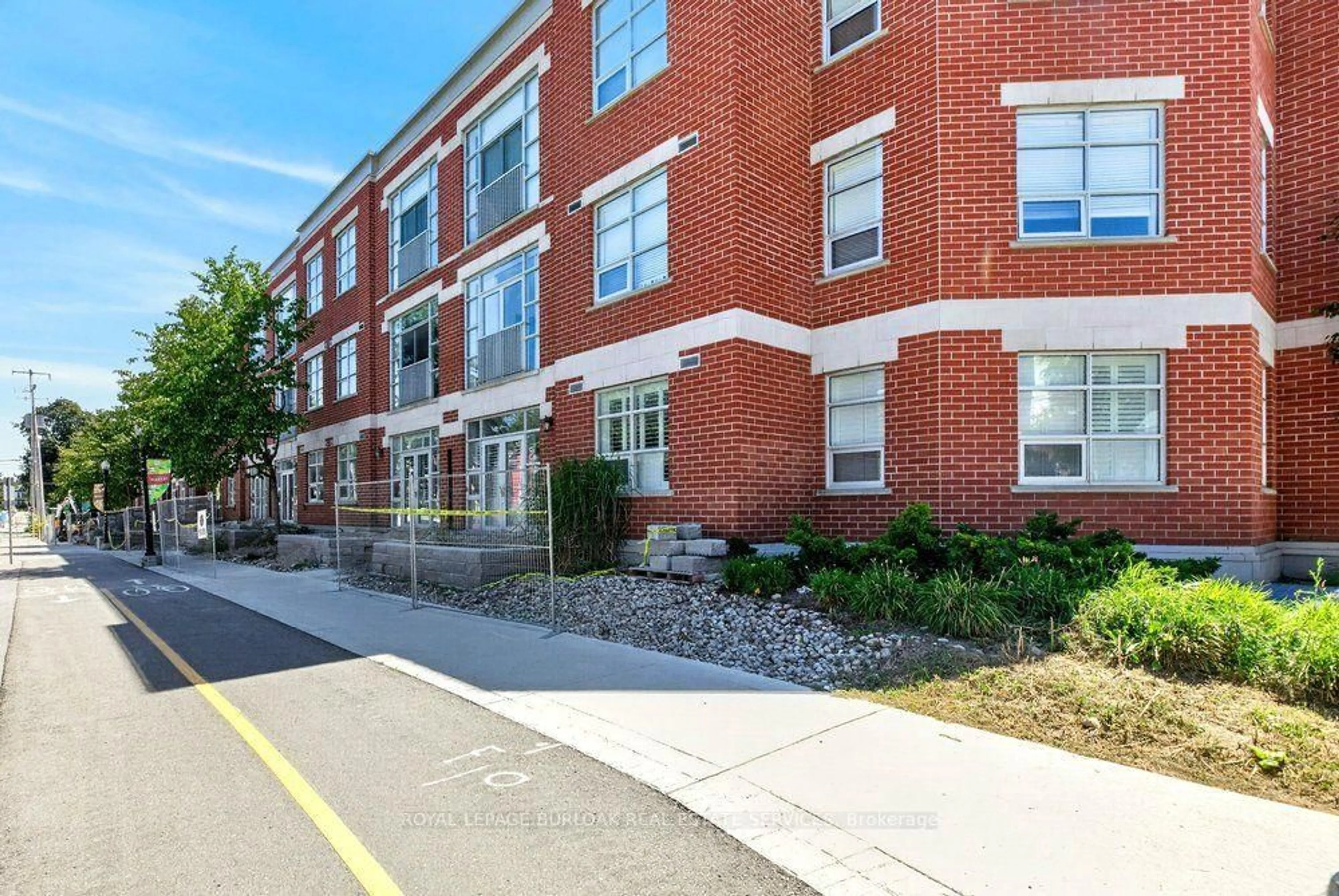 Home with brick exterior material, street for 165 Duke St #107, Kitchener Ontario N2H 6T8