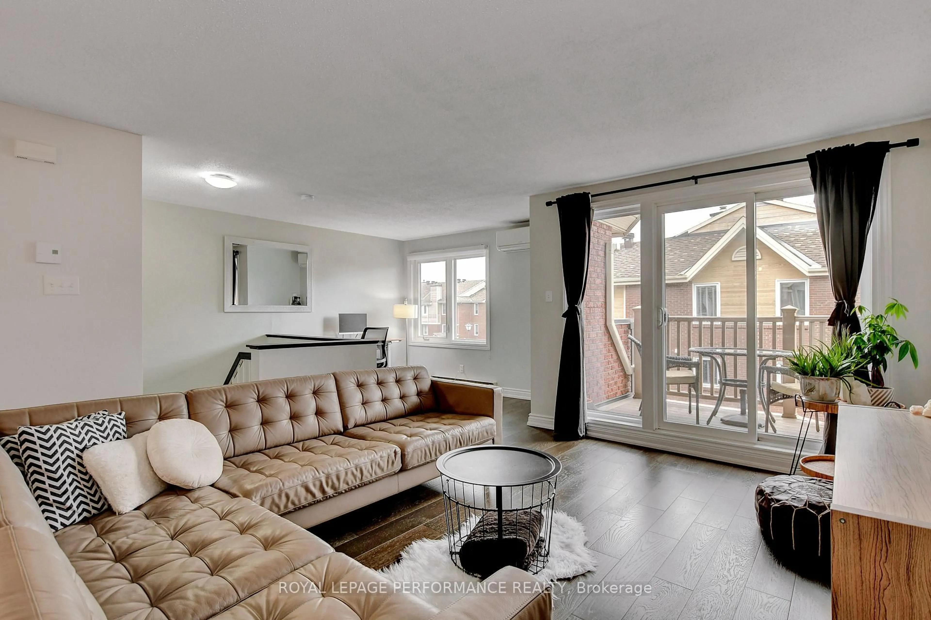 Living room with furniture, wood/laminate floor for 1760 Cabaret Lane #203, Orleans Ontario K4A 2H1