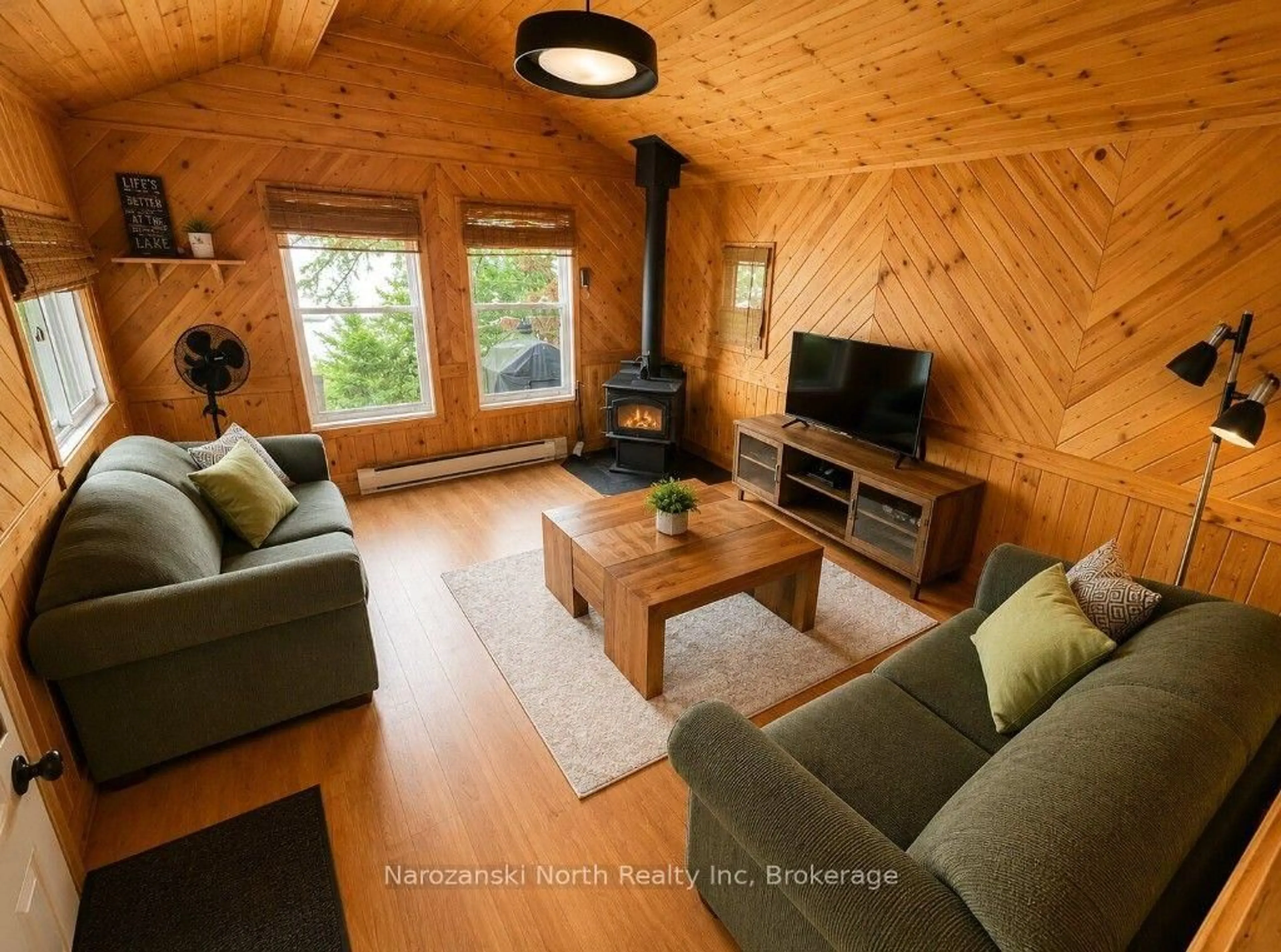 Living room with furniture, wood/laminate floor for 98 West Ham Lake Rd, Killarney Ontario P0M 1A0