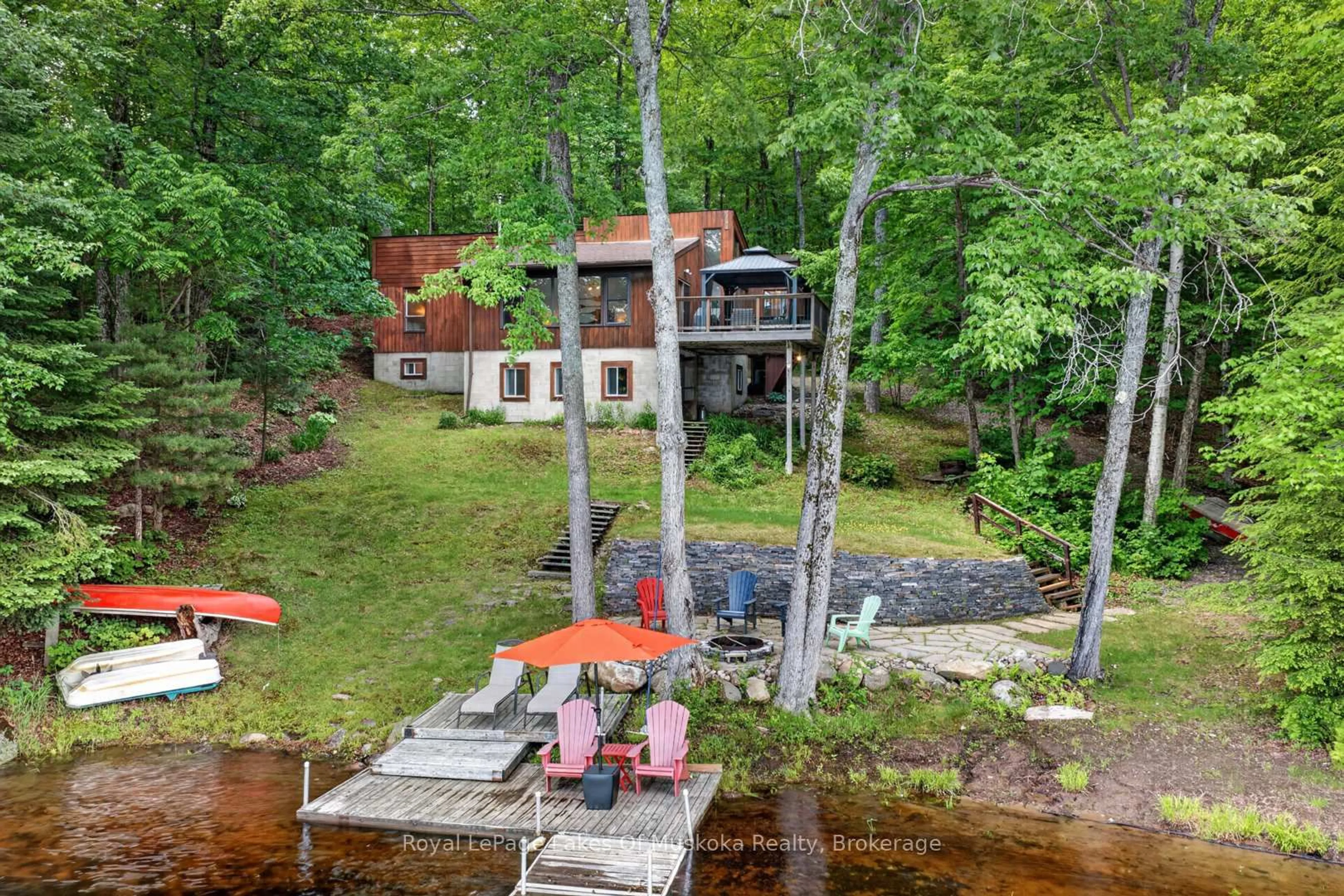 A pic from outside/outdoor area/front of a property/back of a property/a pic from drone, water/lake/river/ocean view for 1008 Seven Dwarfs Cres, Bracebridge Ontario P1L 1X1