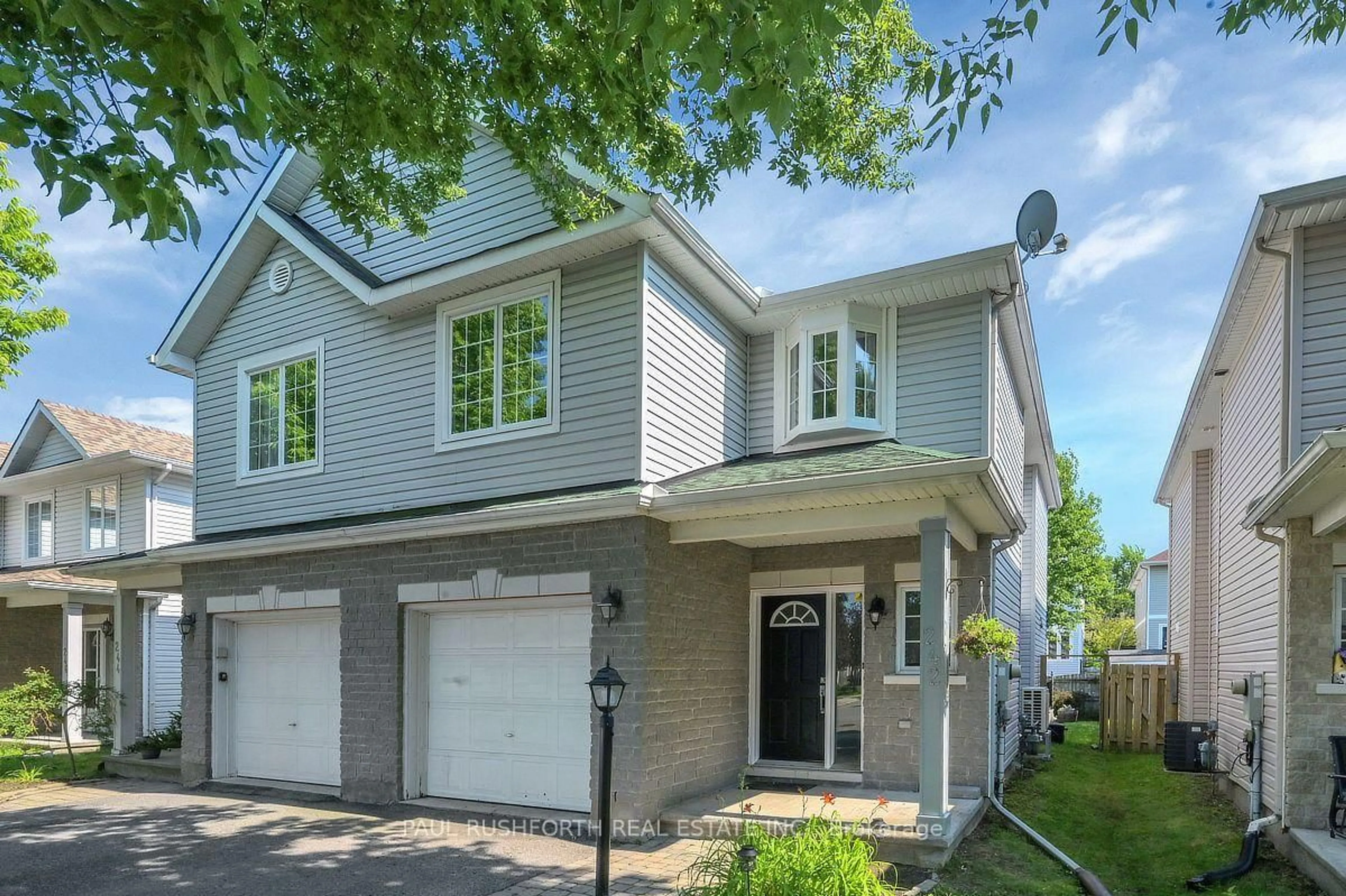 Home with vinyl exterior material, street for 242 Deerfox Dr, Ottawa Ontario K2J 4Z2