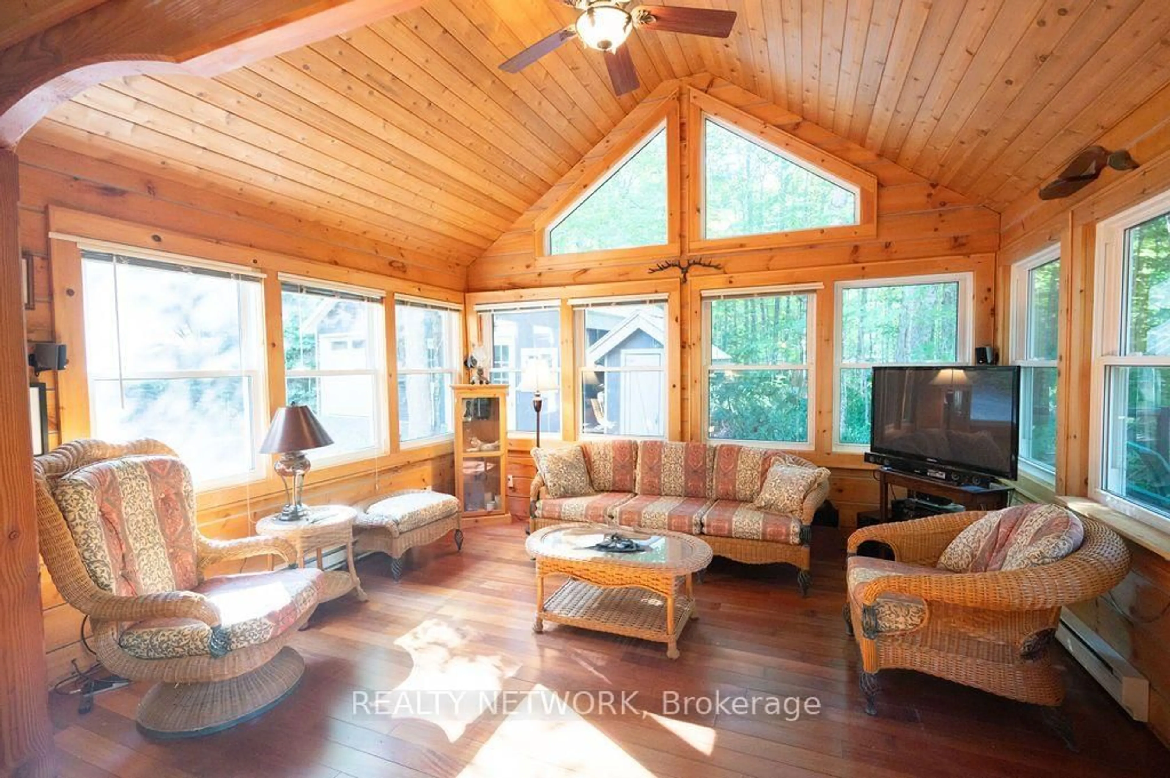 Living room with furniture, wood/laminate floor for 1123 Blue Lake Rd, Lake of Bays Ontario P1H 2J6