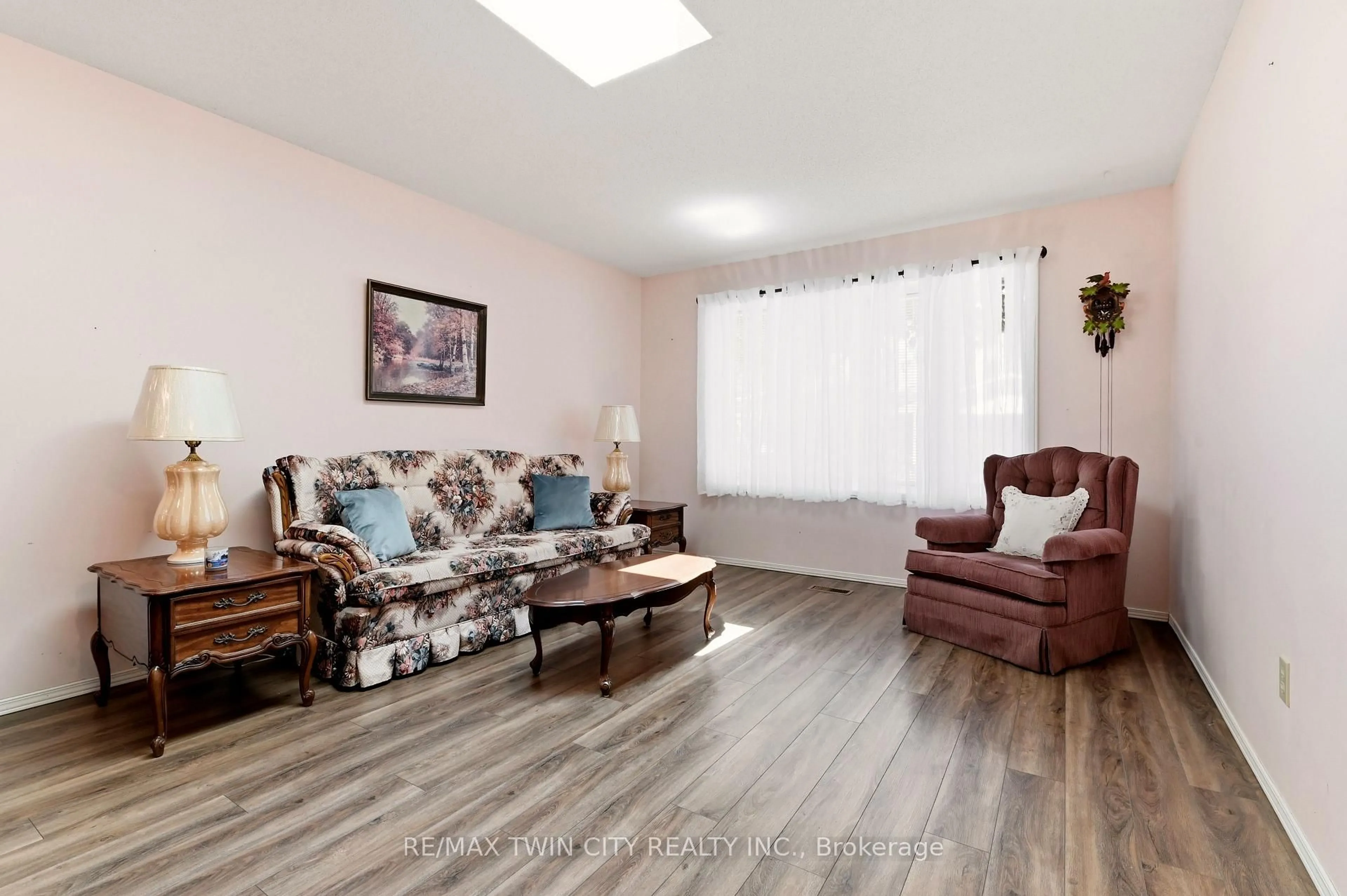 Living room with furniture, wood/laminate floor for 1030 Colborne St, Brantford Ontario N3S 3T6