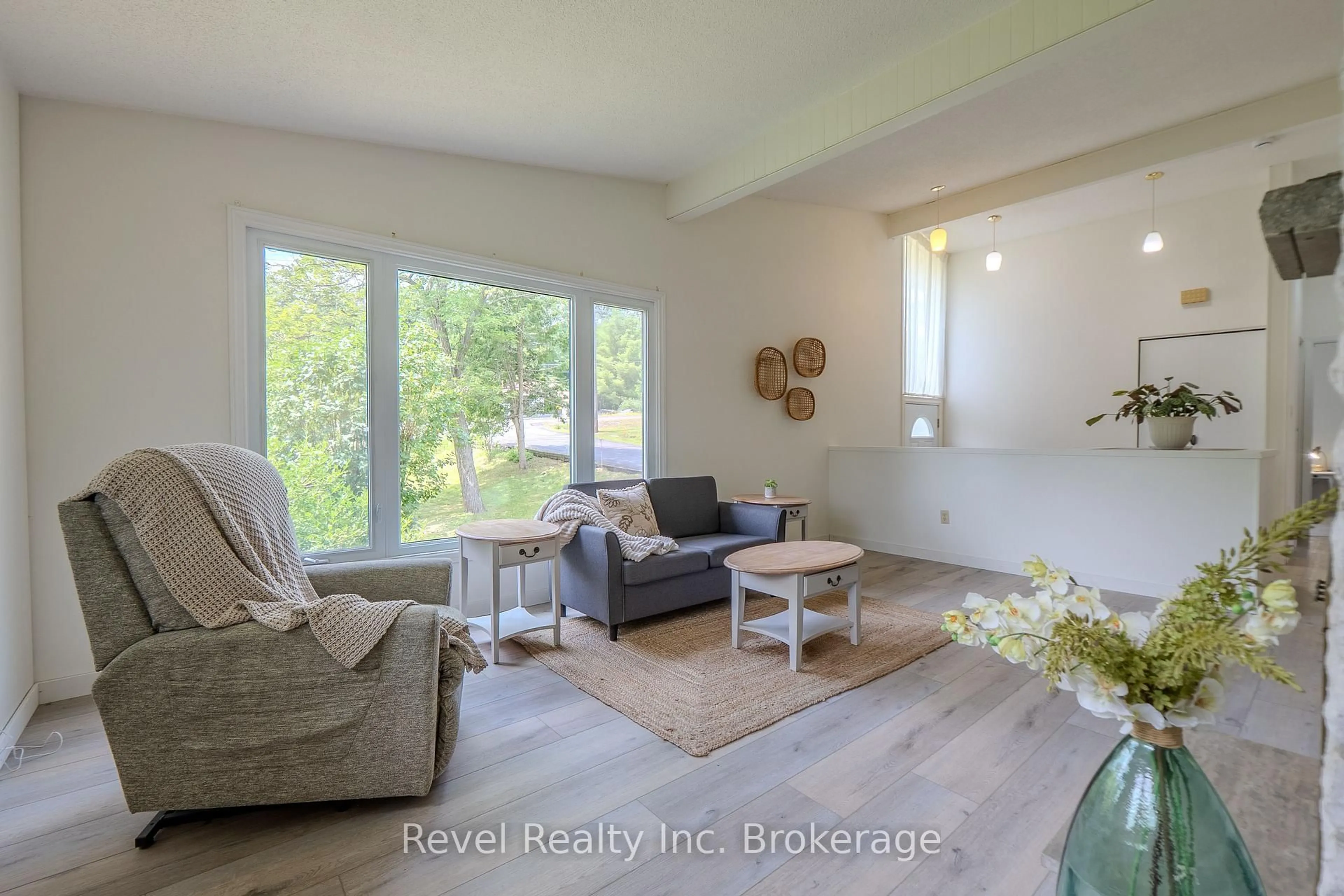 Living room with furniture, wood/laminate floor for 1683 Highway 94, East Ferris Ontario P0H 1K0