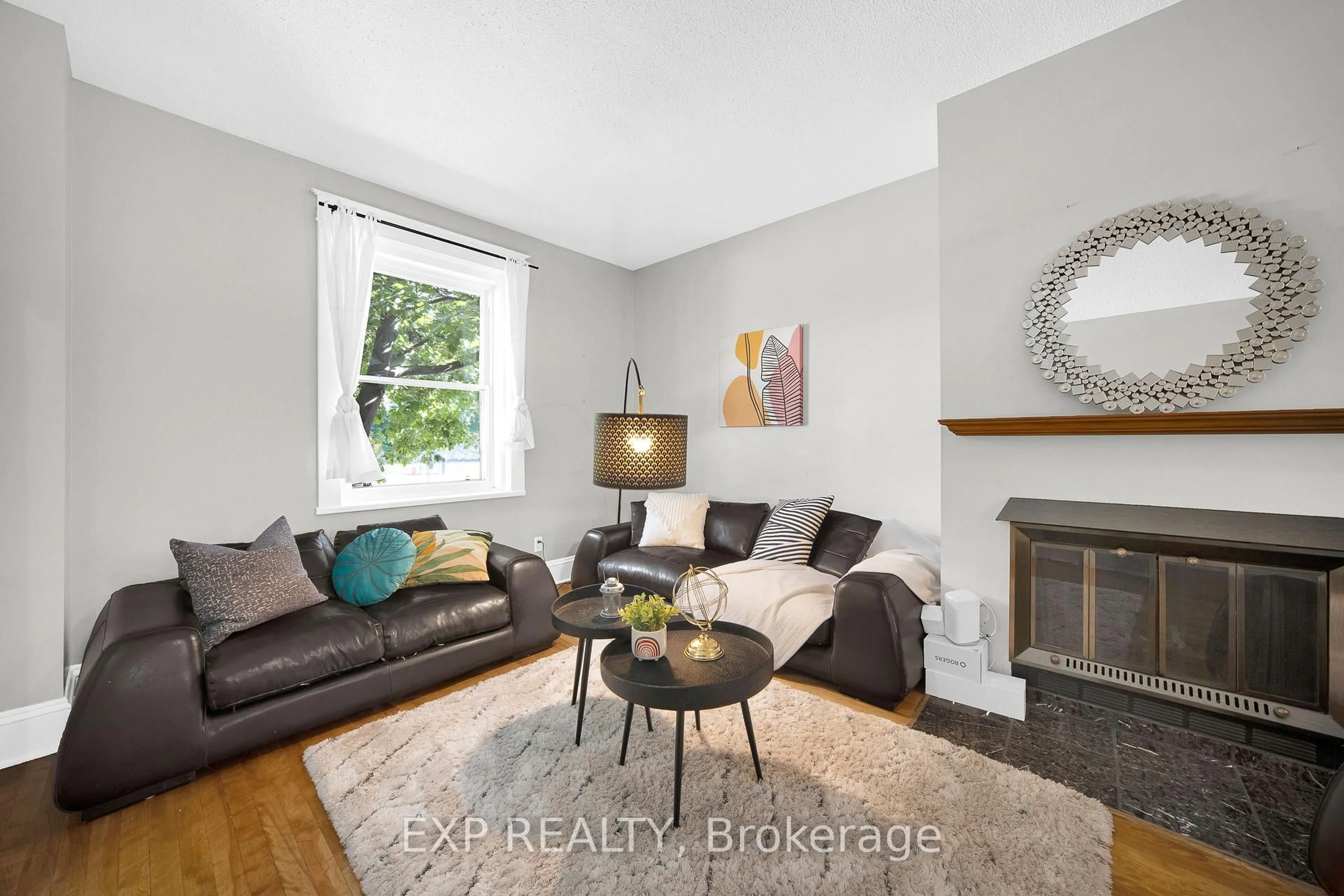 Living room with furniture, wood/laminate floor for 463 Slater St, Ottawa Ontario K1R 5C2