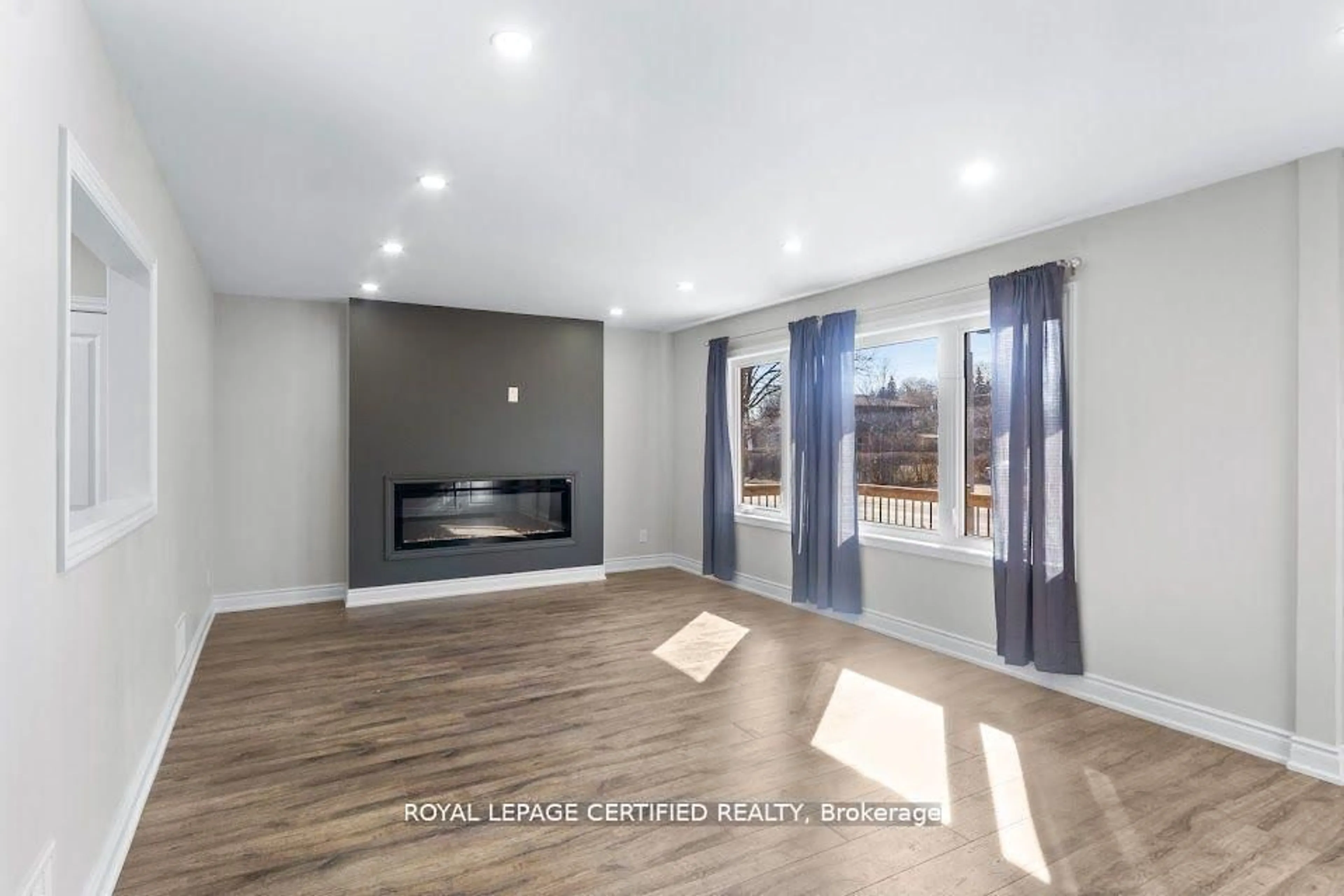 Living room with furniture, wood/laminate floor for 38 Collier Rd, Thorold Ontario L2V 2X3