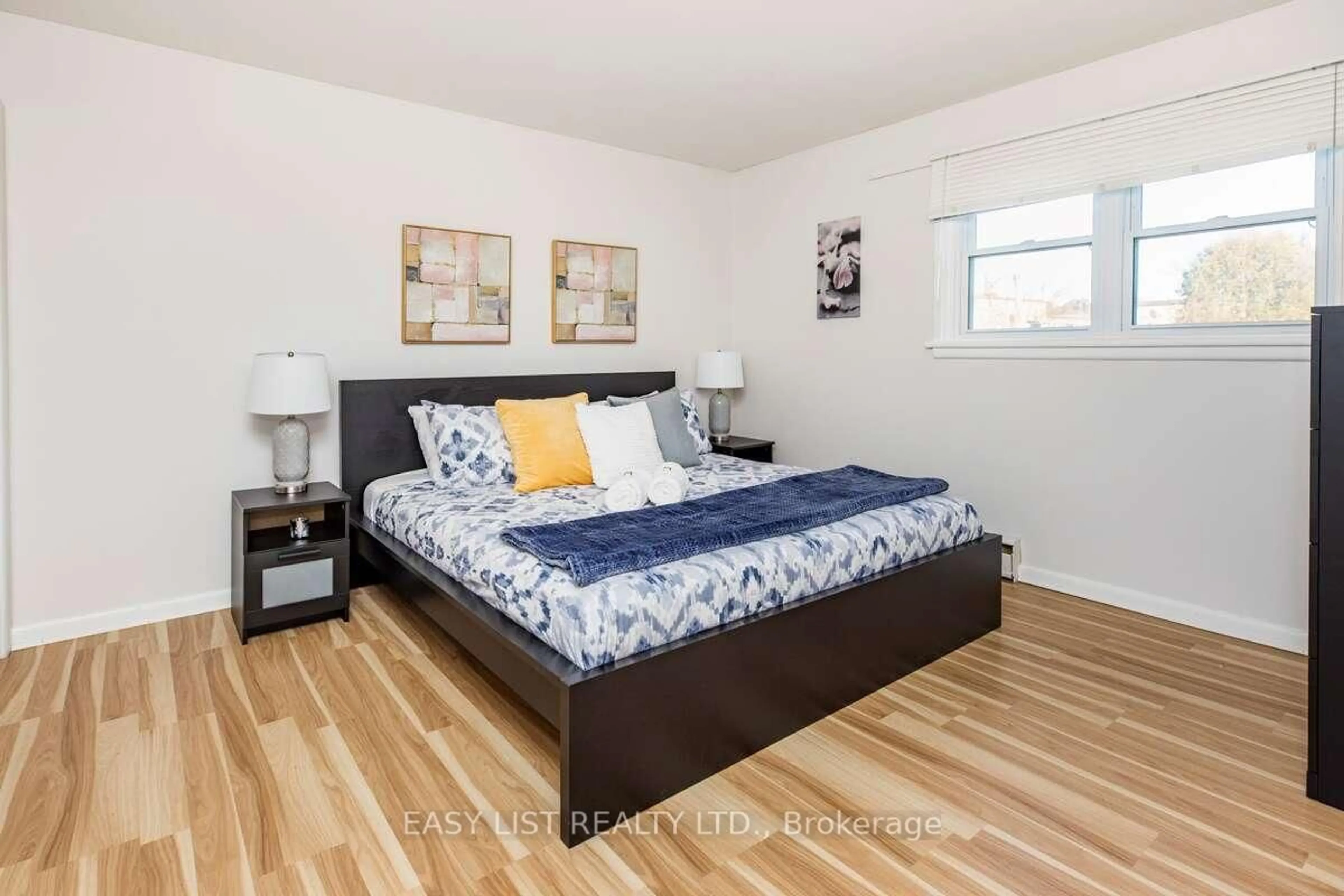 Bedroom with bed, wood/laminate floor for 203 Marier Ave, Ottawa Ontario K1L 5R6