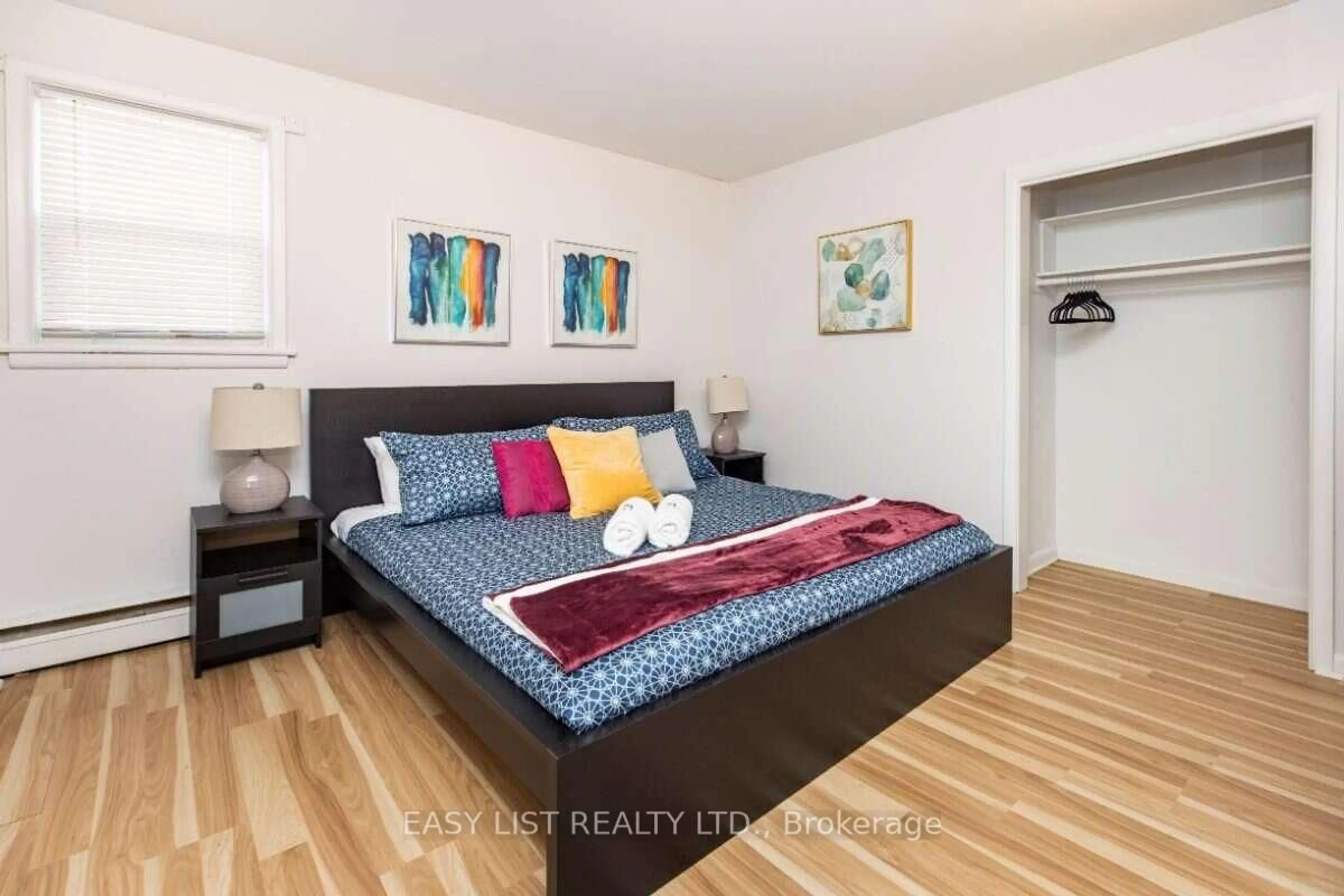 Bedroom with bed, wood/laminate floor for 203 Marier Ave, Ottawa Ontario K1L 5R6