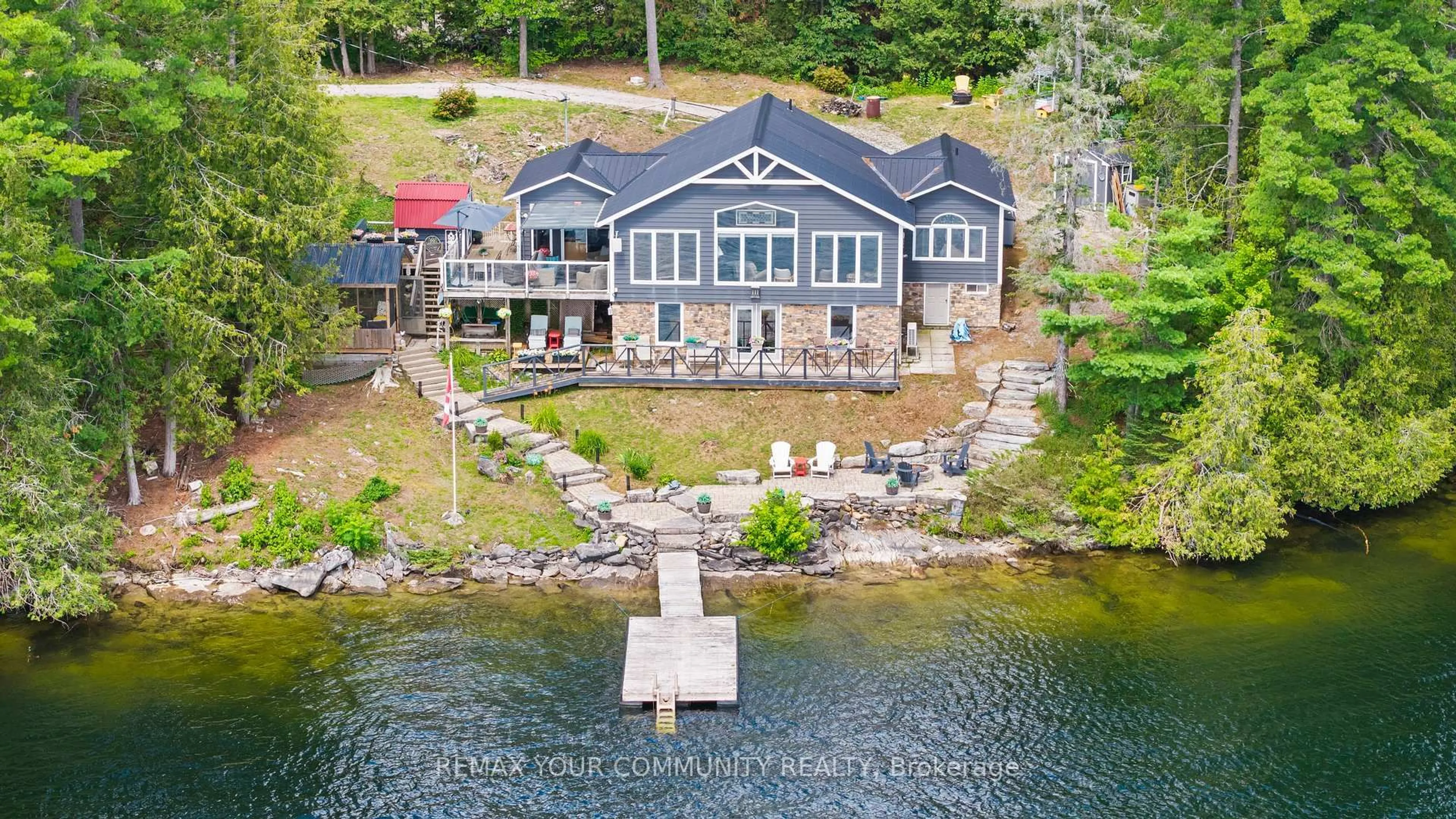 A pic from outside/outdoor area/front of a property/back of a property/a pic from drone, water/lake/river/ocean view for 511 East Clear Bay Rd, Trent Lakes Ontario K0M 2A0