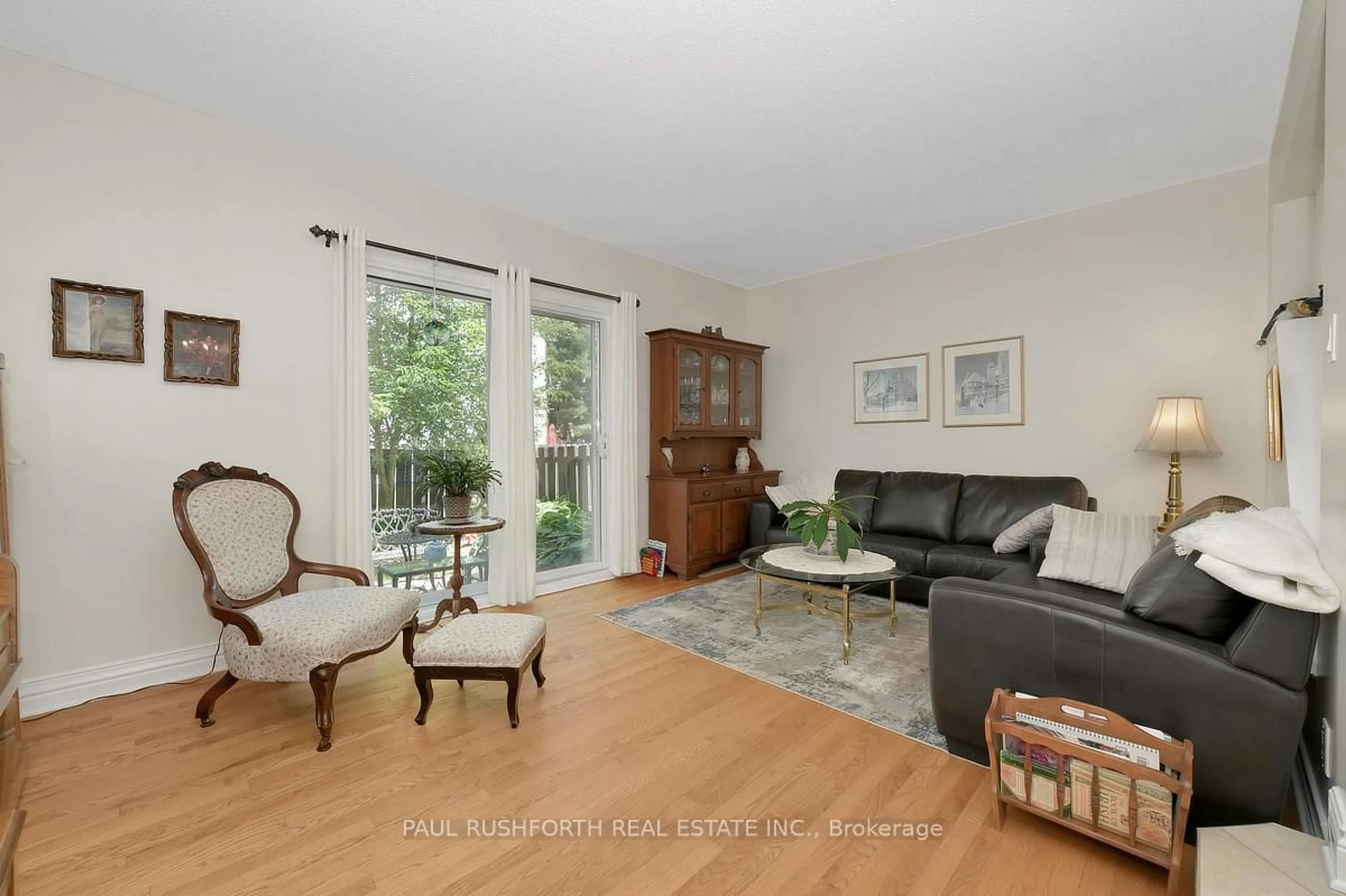 Living room with furniture, wood/laminate floor for 6426 Nuggett Dr, Orleans Ontario K1C 4X8