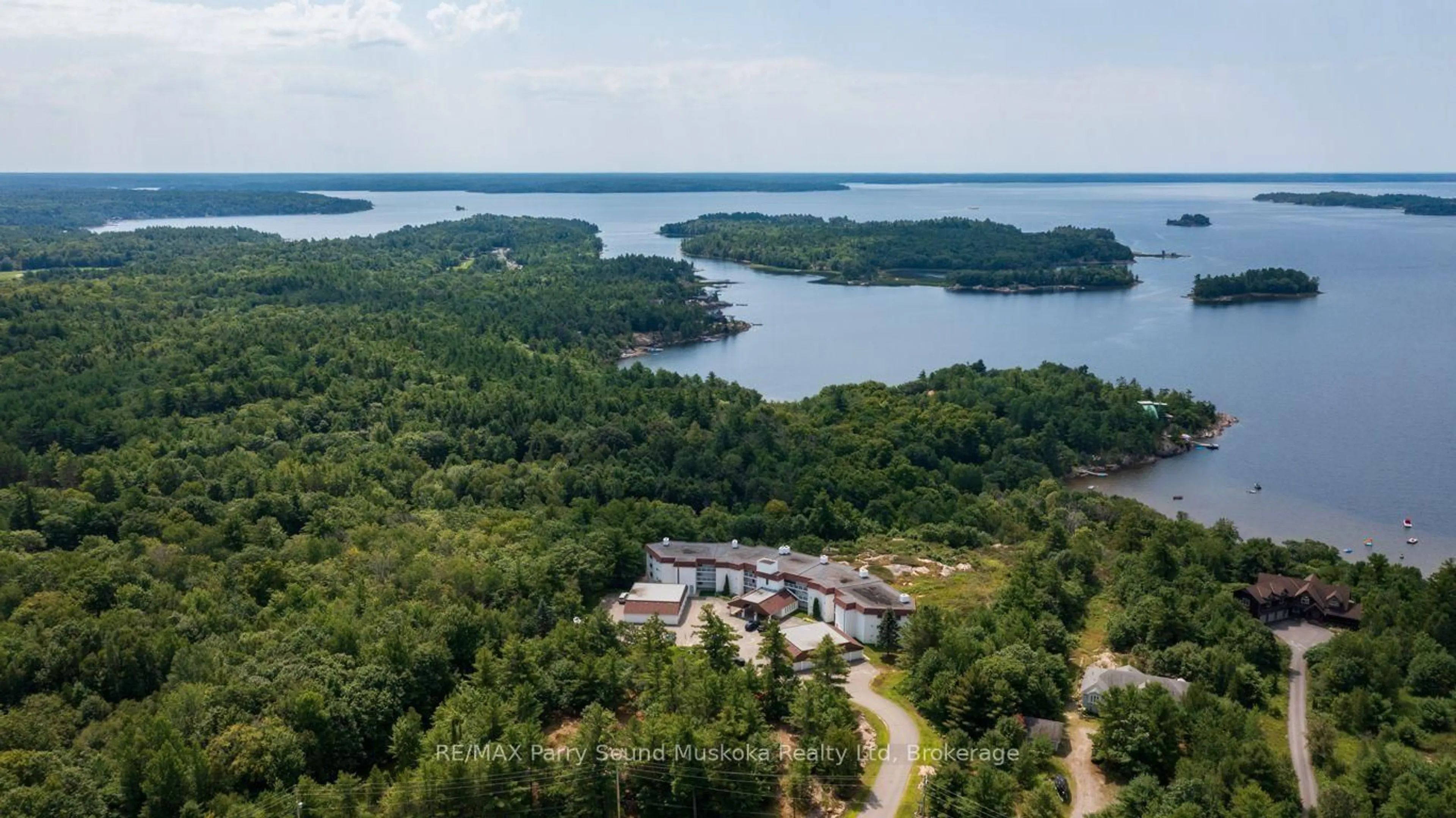 A pic from outside/outdoor area/front of a property/back of a property/a pic from drone, water/lake/river/ocean view for 20 Ryder Dr #3B, McDougall Ontario P2A 2W9