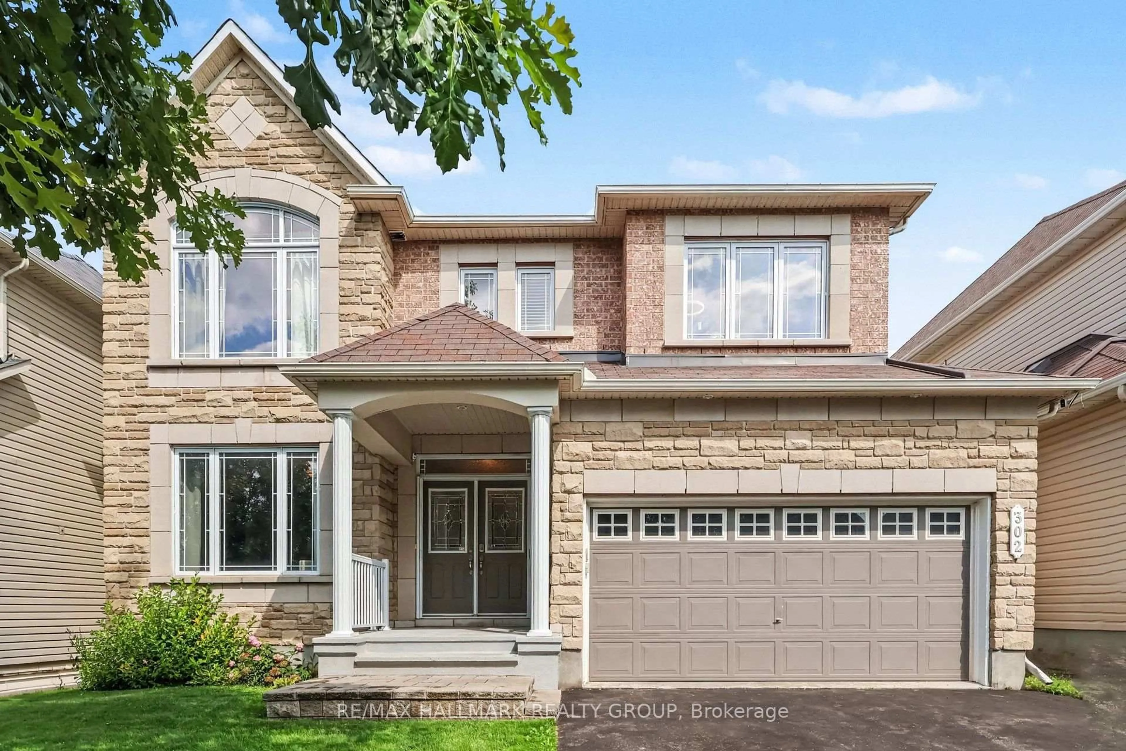 Home with brick exterior material, street for 302 Grayburn Way, Ottawa Ontario K2J 0V8