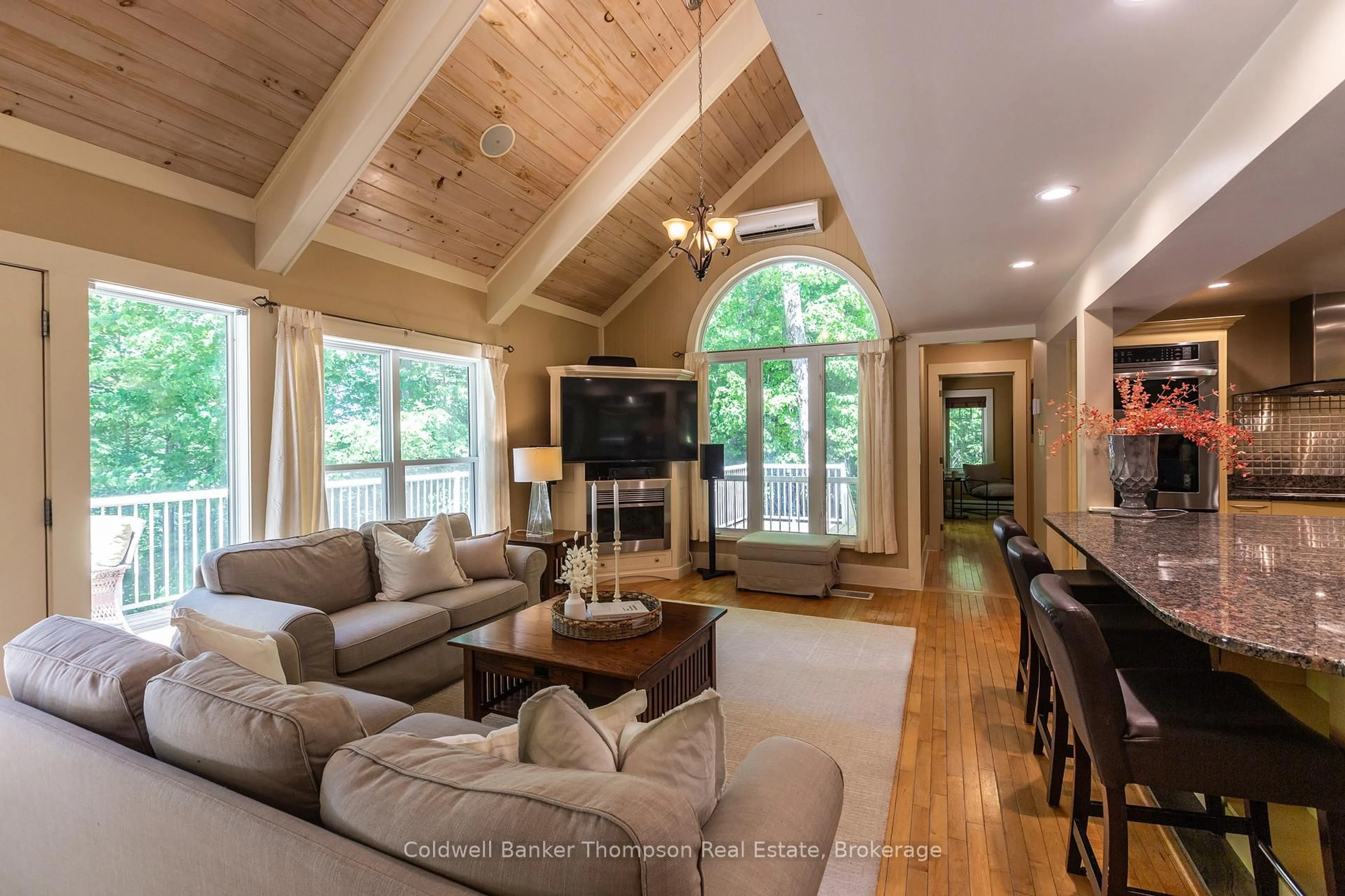 Living room with furniture, wood/laminate floor for 312 Swallowdale Rd, Huntsville Ontario P1H 0A5