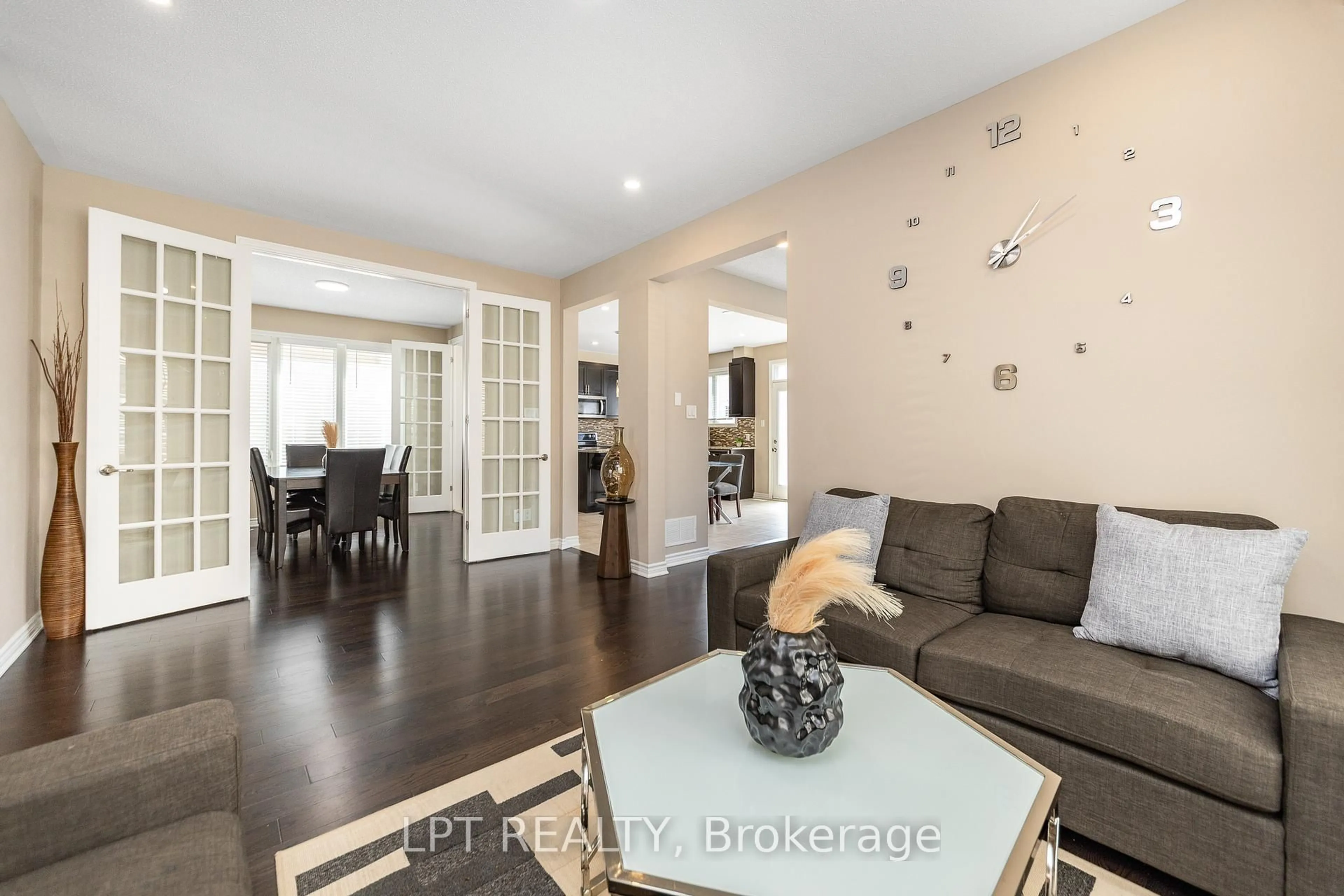 Living room with furniture, wood/laminate floor for 908 Pedigree St, Stittsville Ontario K2S 0Y5