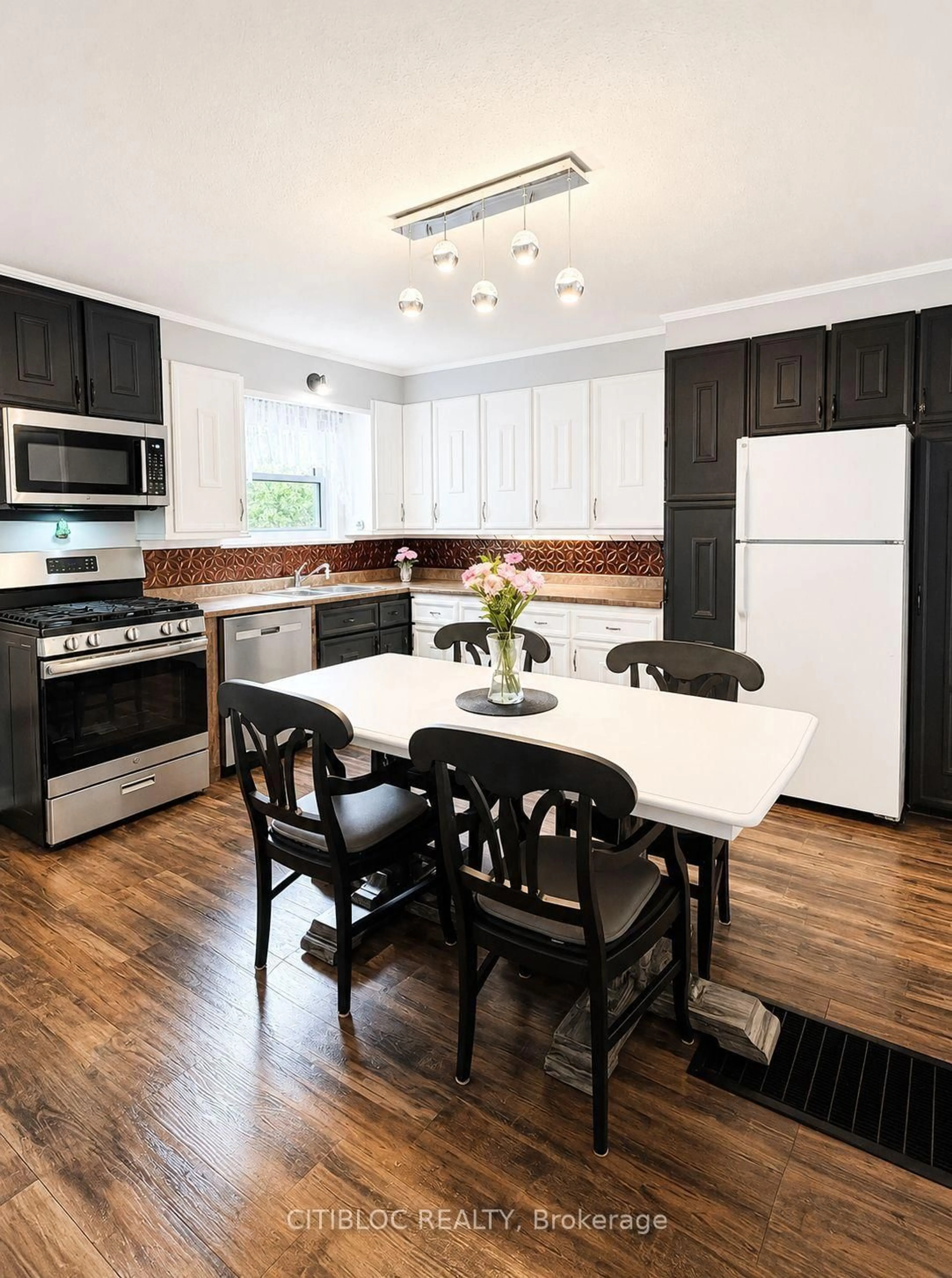 Open concept kitchen, wood/laminate floor for 67 Ottawa Ave, South River Ontario P0A 1X0