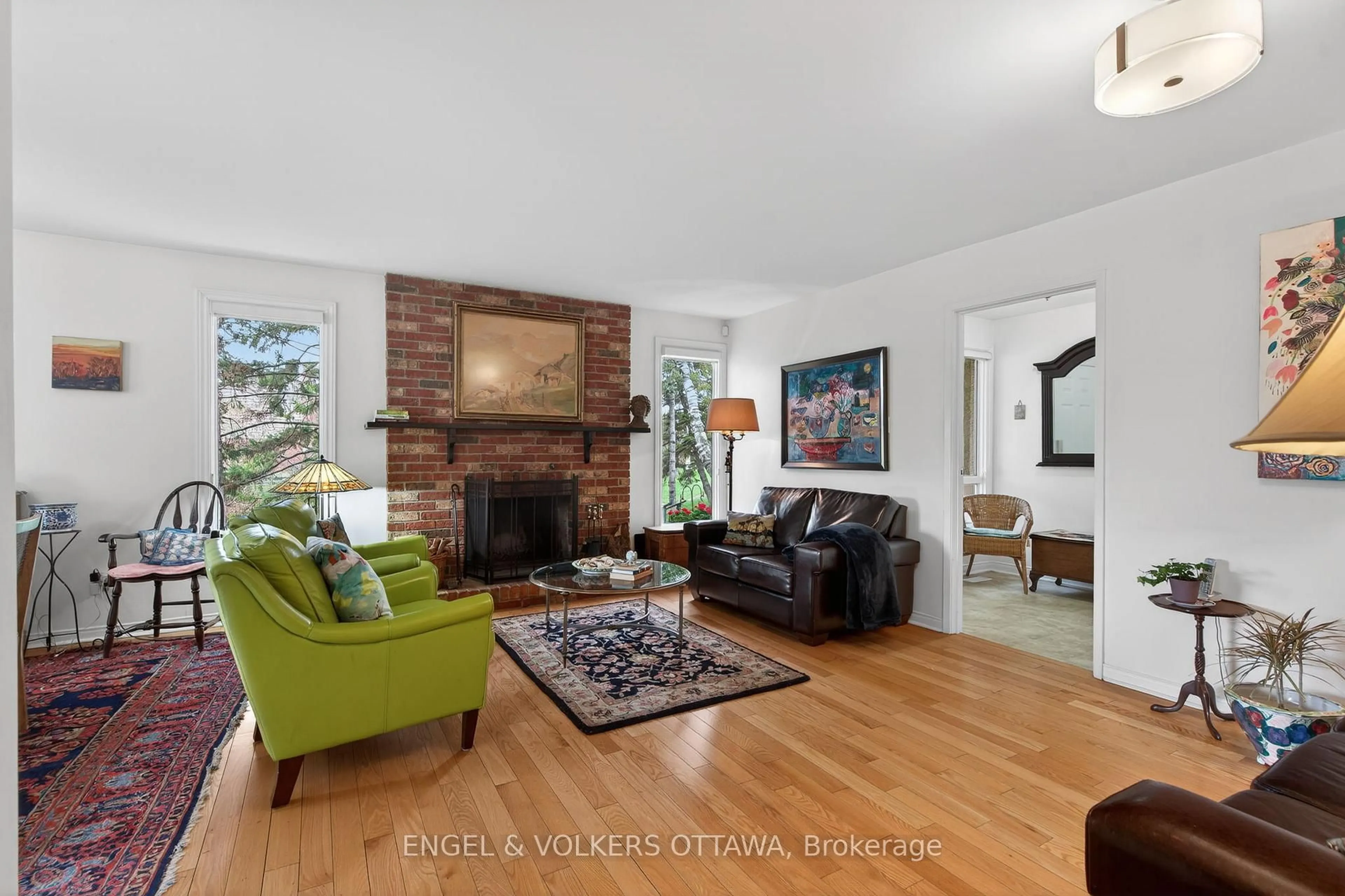 Living room with furniture, wood/laminate floor for 3344 Uplands Dr #77, Ottawa Ontario K1V 9R9