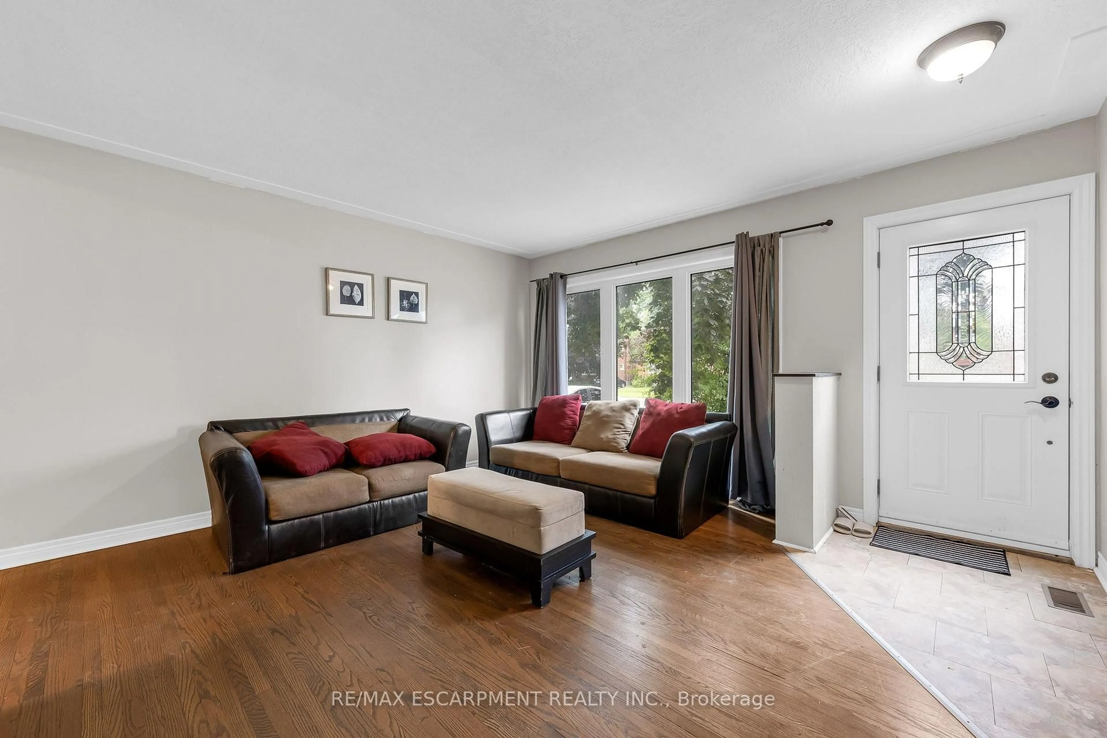 Living room with furniture, wood/laminate floor for 203B Erb St, Waterloo Ontario N2J 1M7