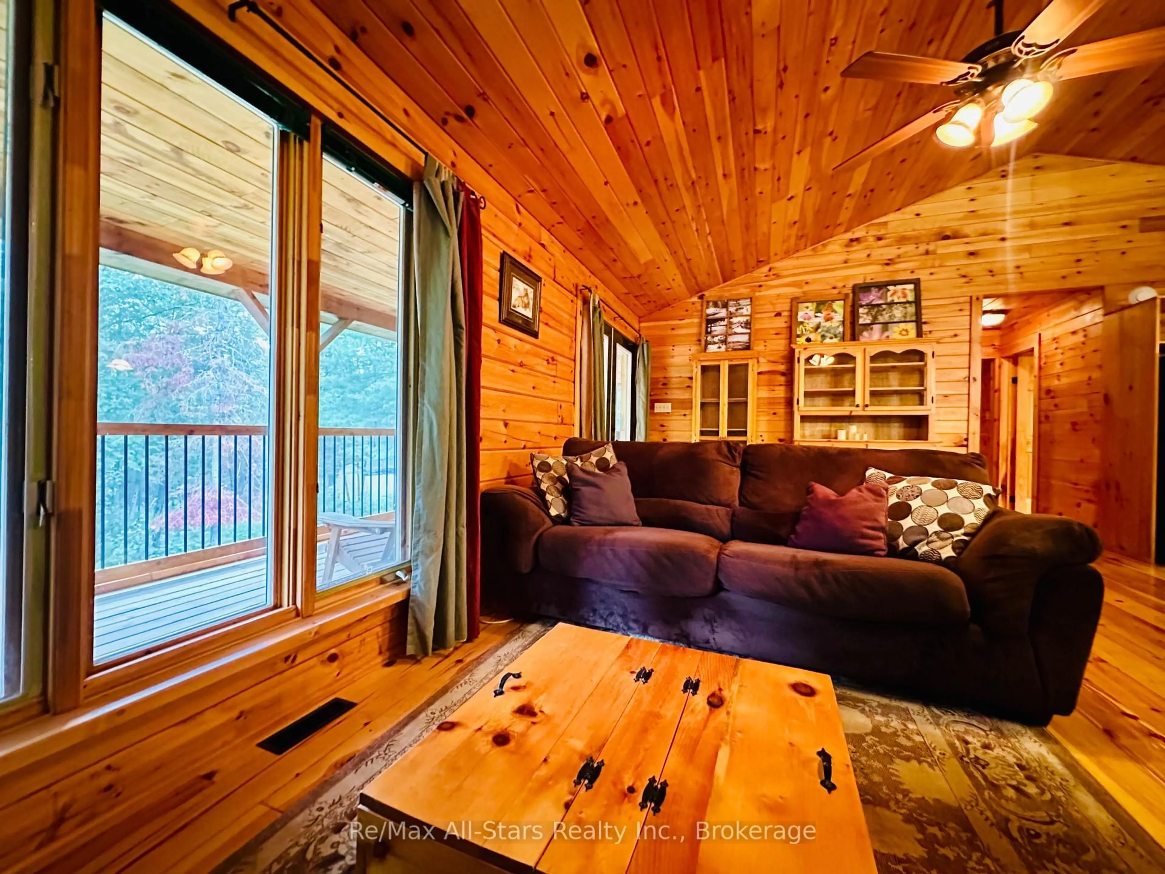 Living room with furniture, wood/laminate floor for 7140 Highway 28, North Kawartha Ontario K0L 3E0