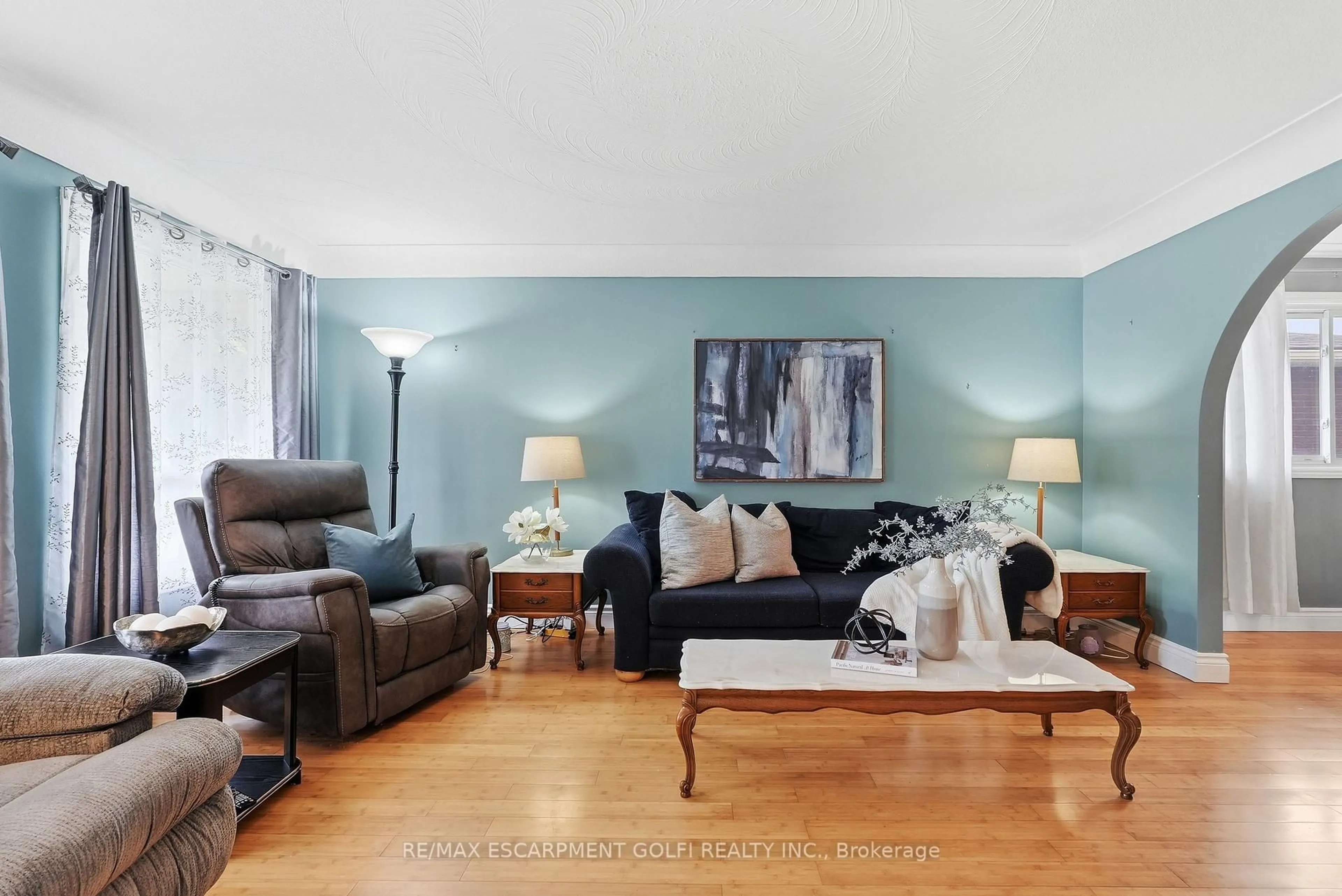Living room with furniture, wood/laminate floor for 377 Carson Dr, Hamilton Ontario L8T 4T8