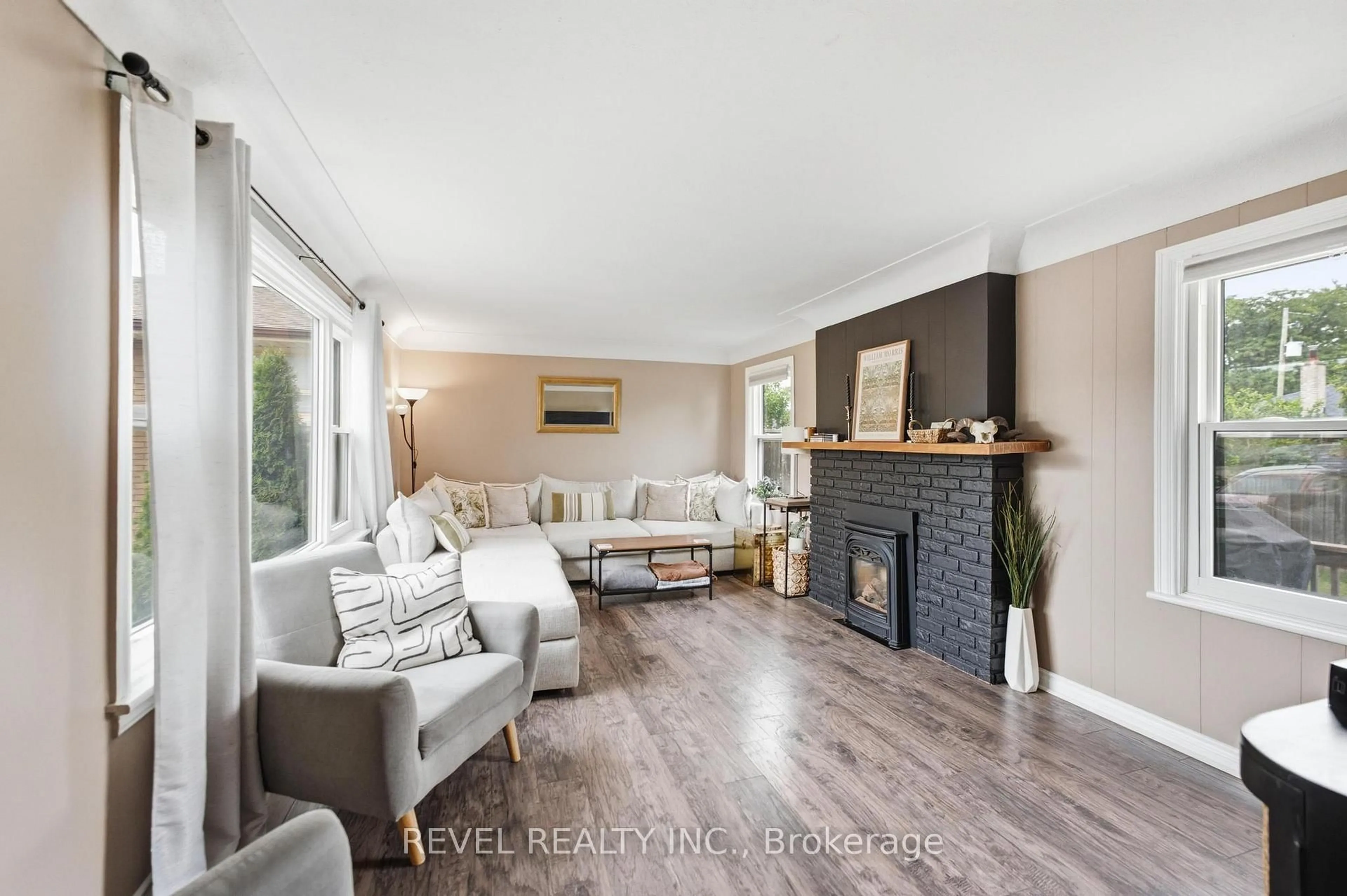 Living room with furniture, wood/laminate floor for 481 Upper Gage Ave, Hamilton Ontario L8V 4J2