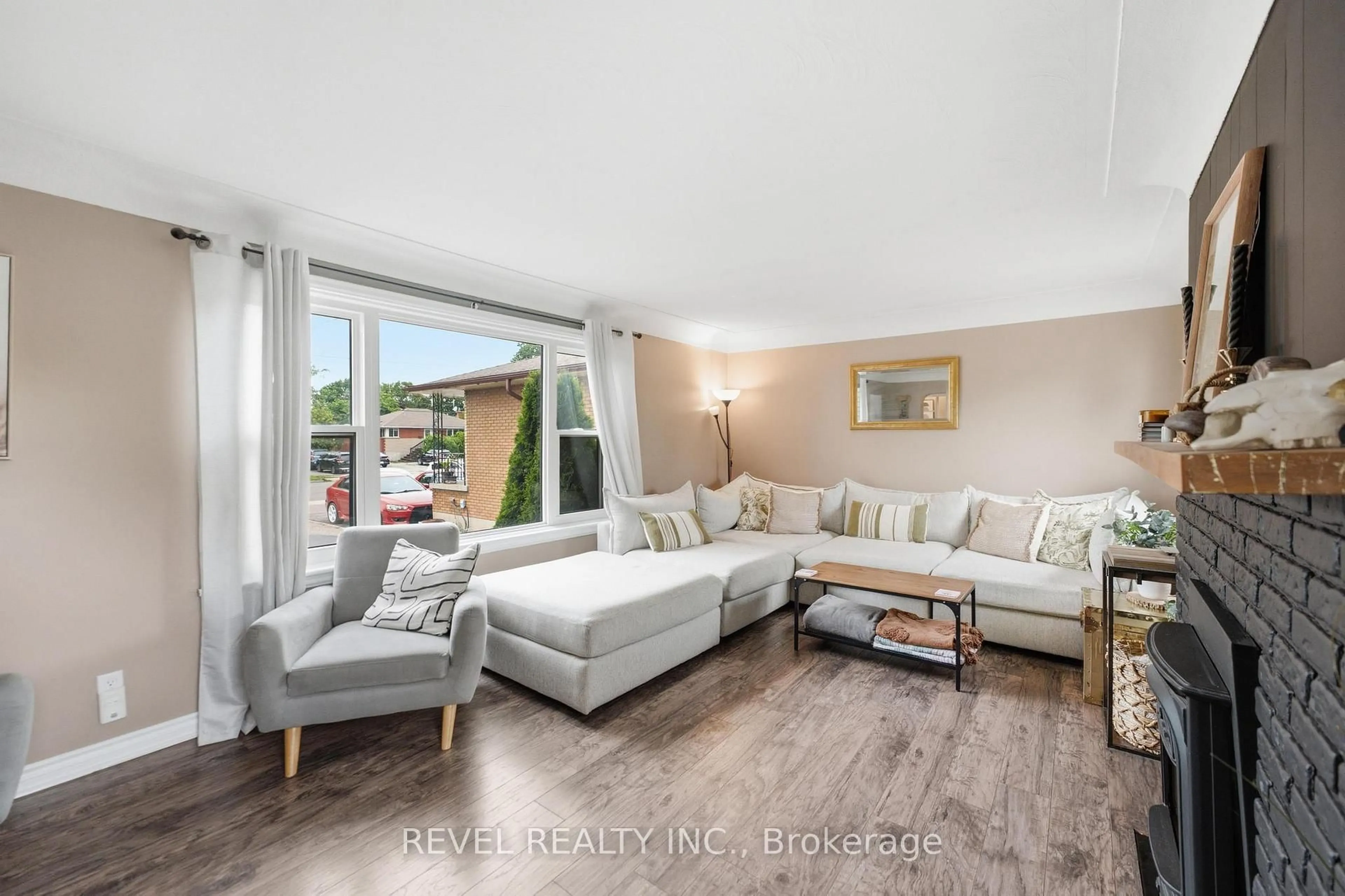 Living room with furniture, wood/laminate floor for 481 Upper Gage Ave, Hamilton Ontario L8V 4J2