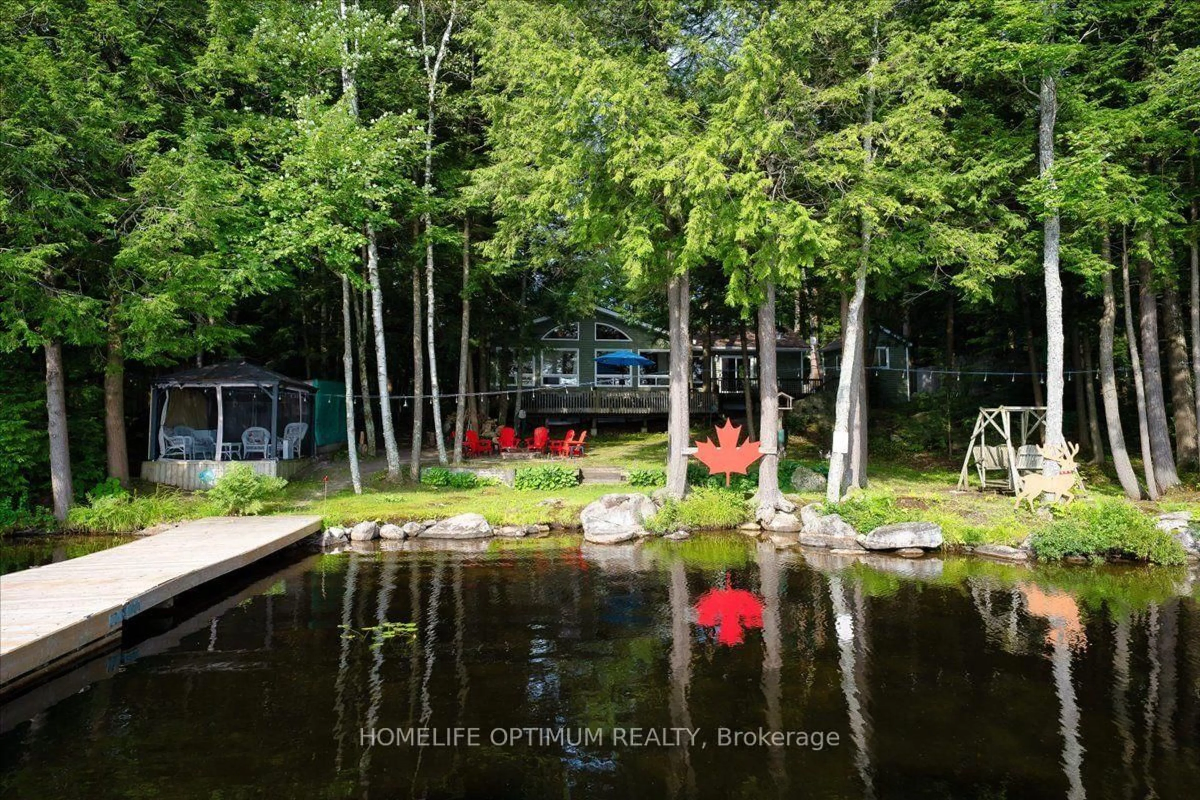 A pic from outside/outdoor area/front of a property/back of a property/a pic from drone, water/lake/river/ocean view for 1195 Lakeshore Dr, Bracebridge Ontario P1L 1X3
