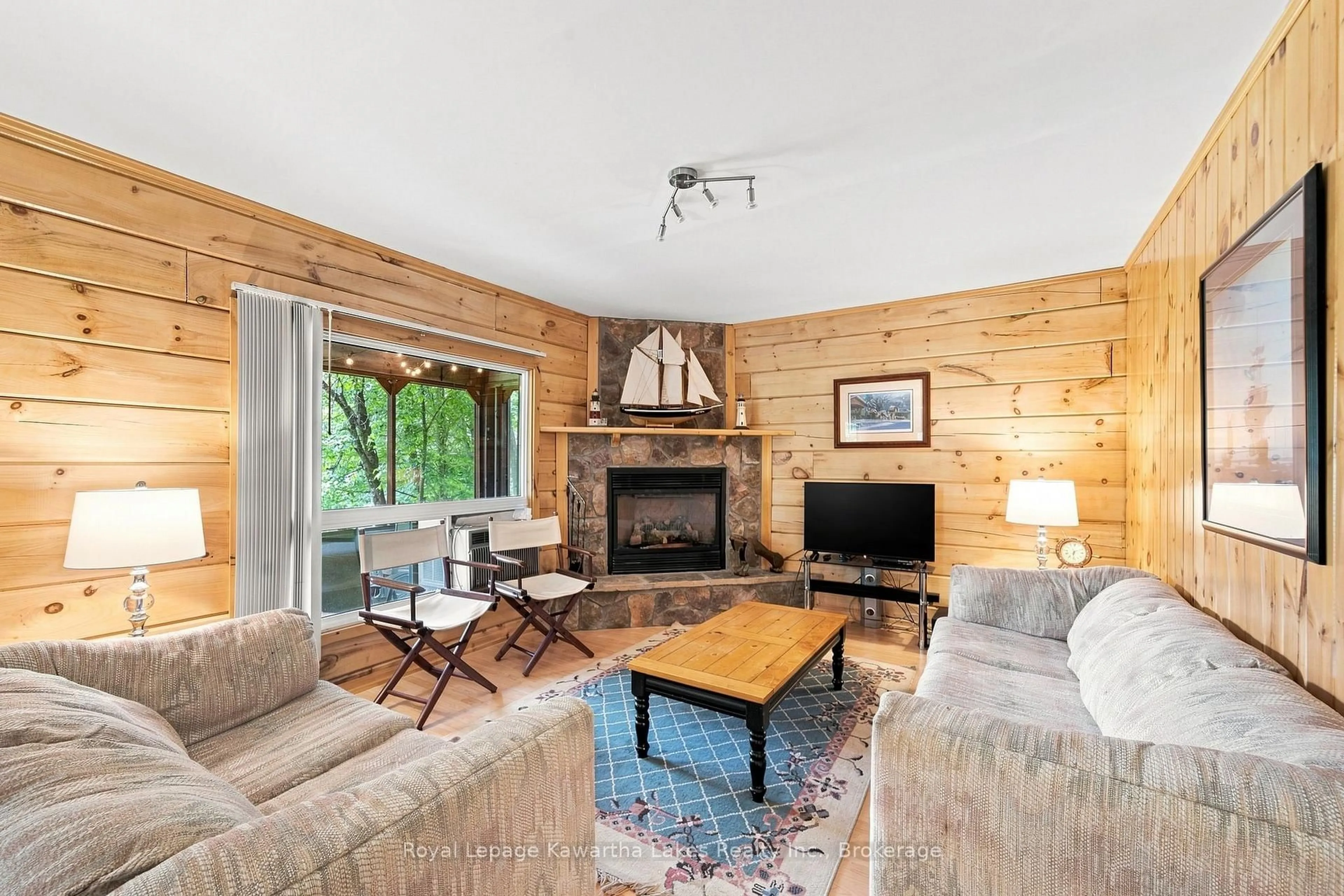 Living room with furniture, wood/laminate floor for 9 Crooked Crt, Kawartha Lakes Ontario K0M 1N0